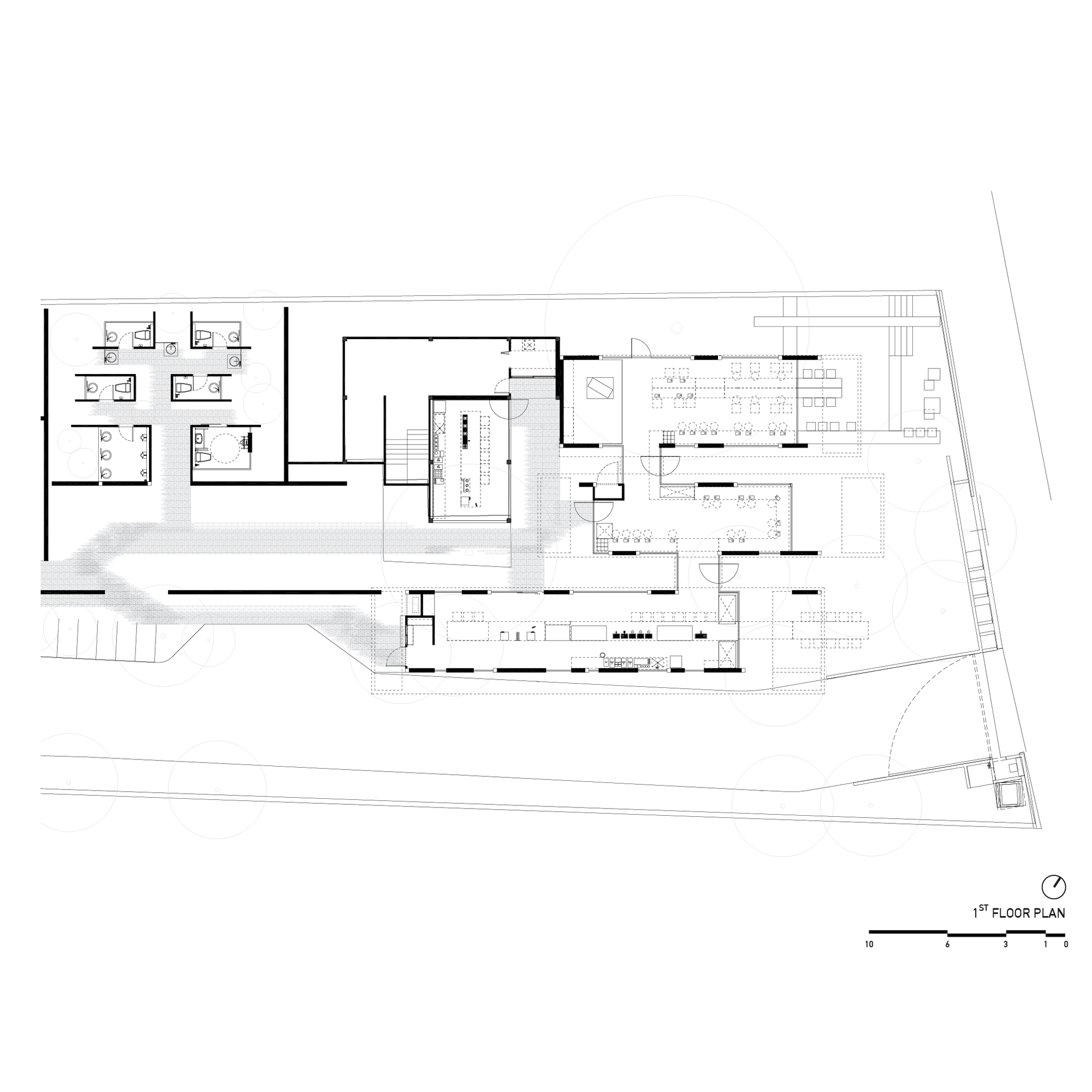 First floor plan drawing showing dining areas, kitchen, office spaces, and a curved outdoor terrace