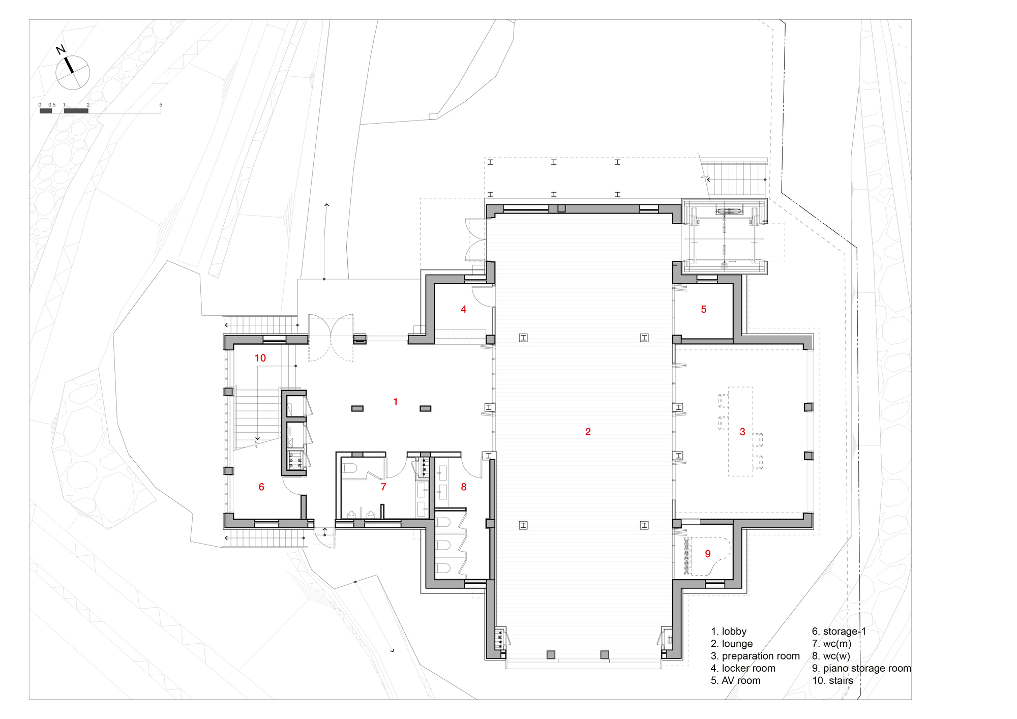 Floor plan drawing depicting a large central lounge space with surrounding service rooms and curved site boundary
