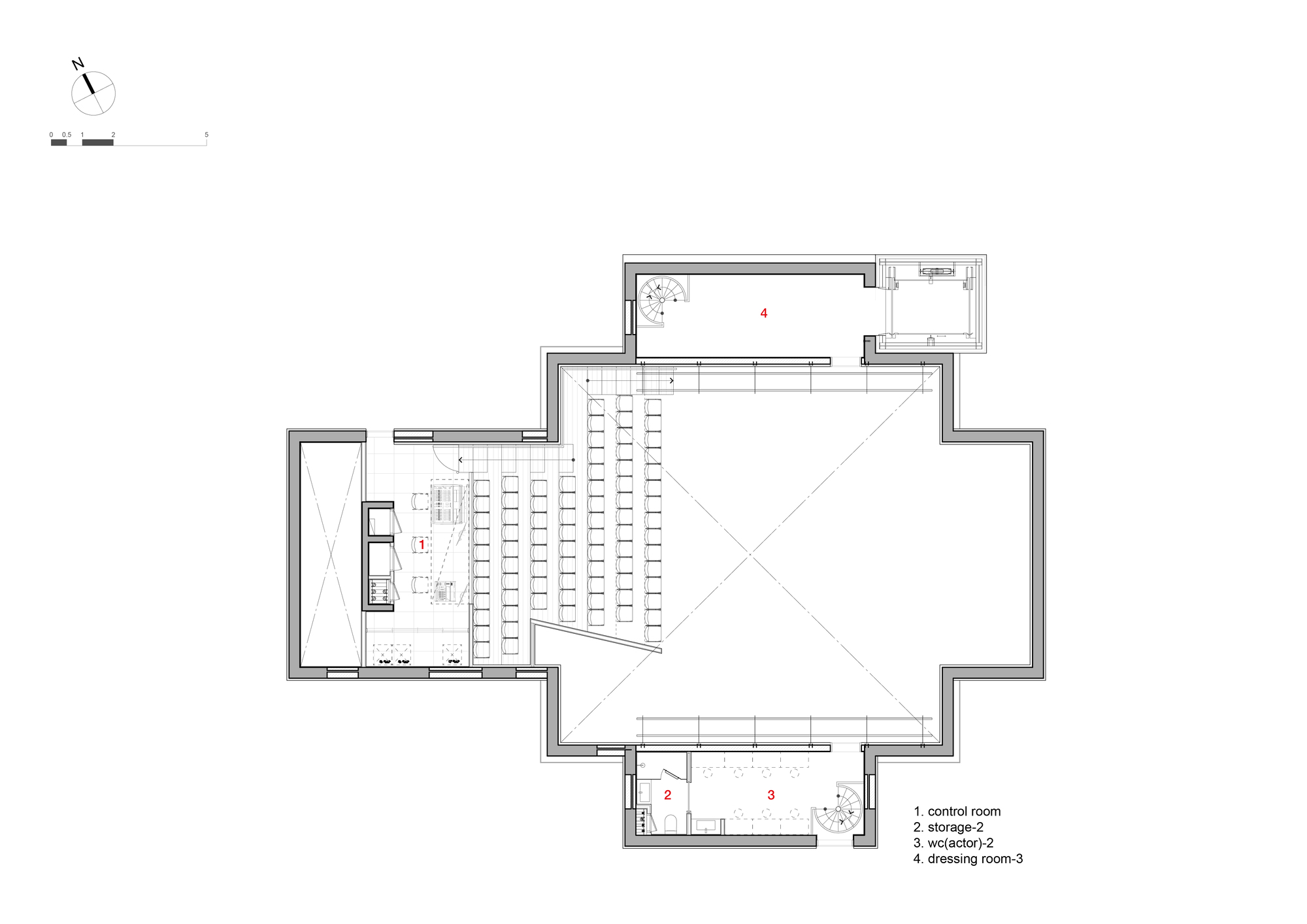 Floor plan showing an auditorium with angled seating rows and adjacent backstage and support spaces