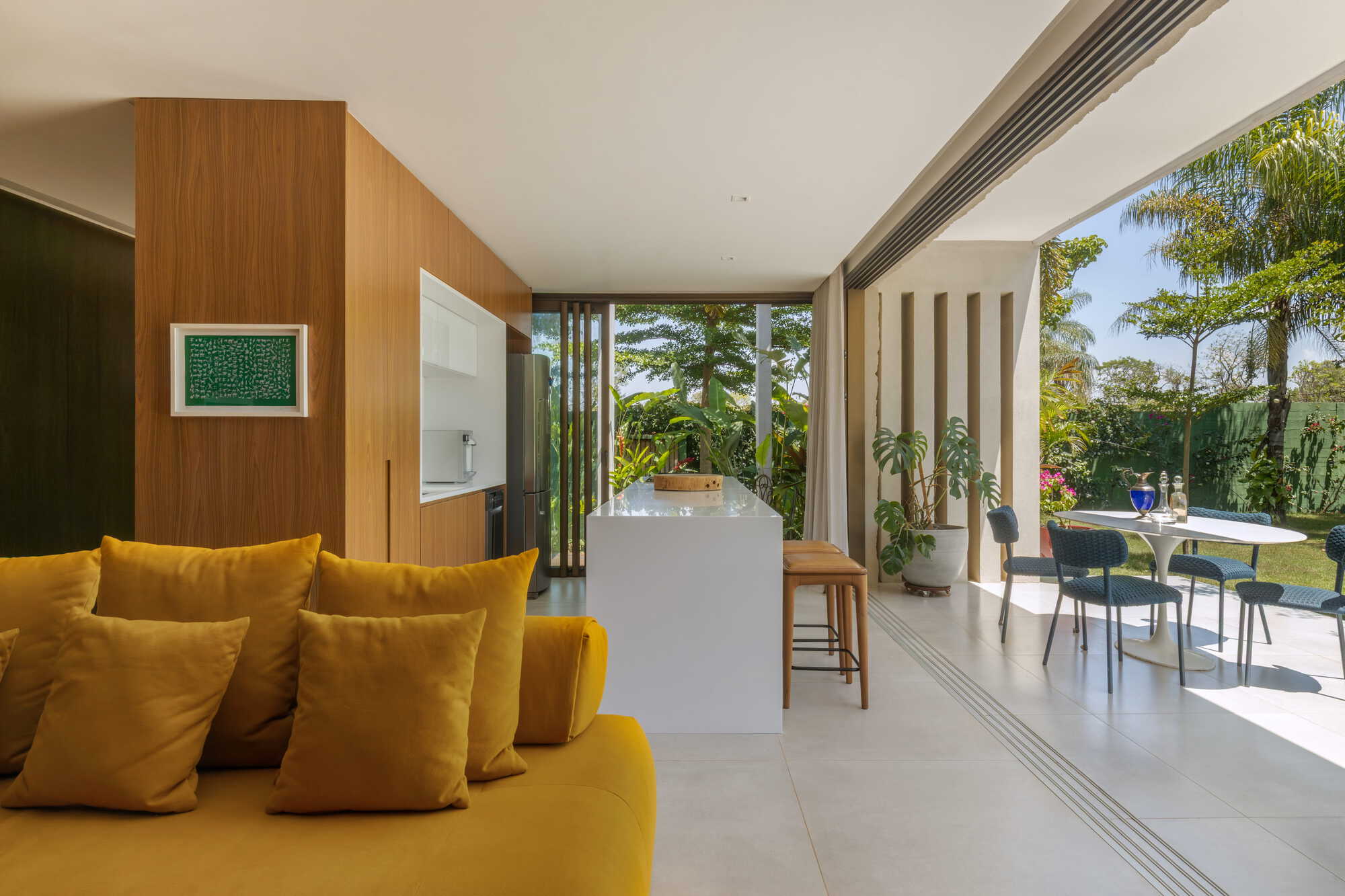 Living area with sliding glass doors connecting interior to covered terrace and garden