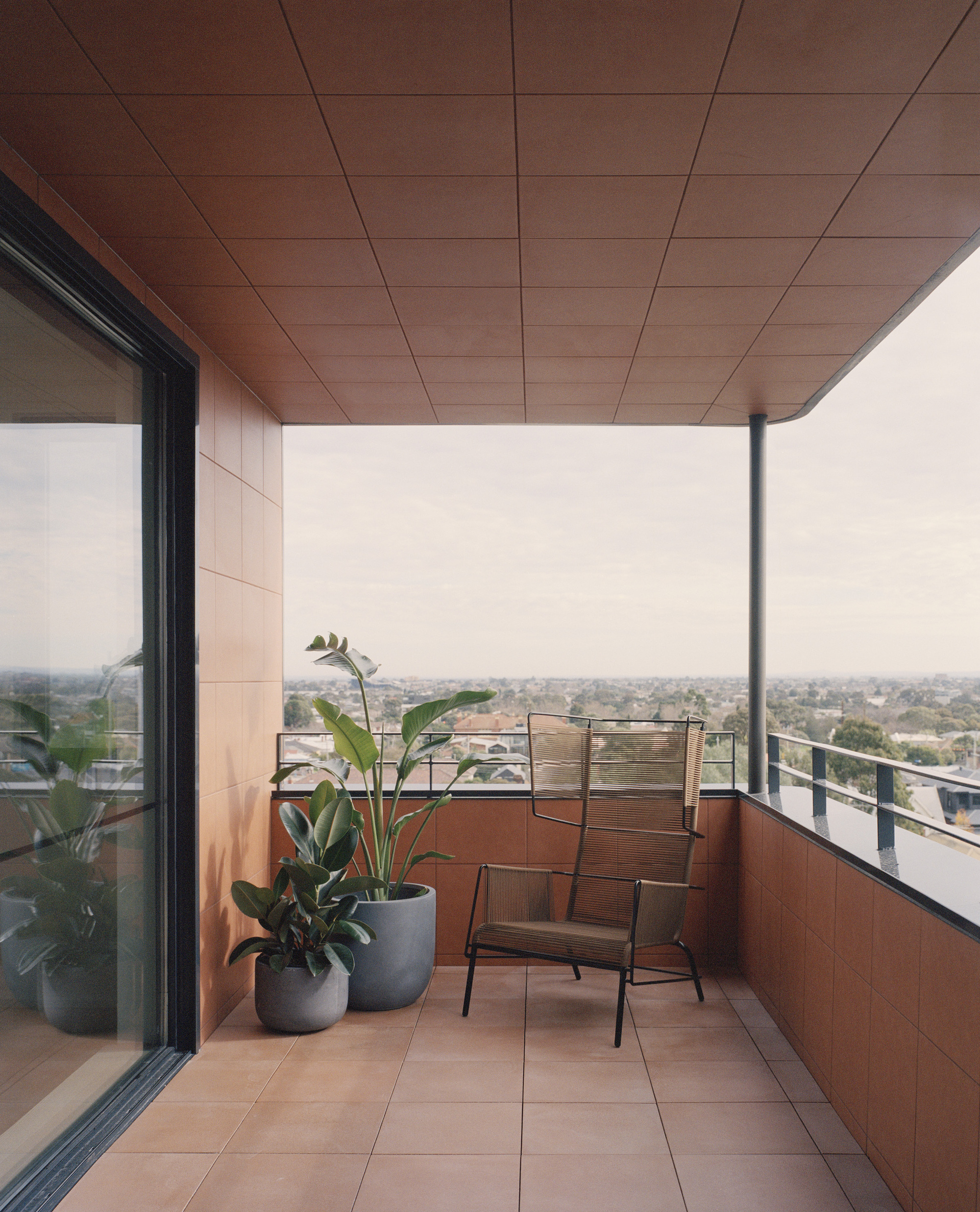 Private terrace with tile floor, timber ceiling soffit and city views in haze