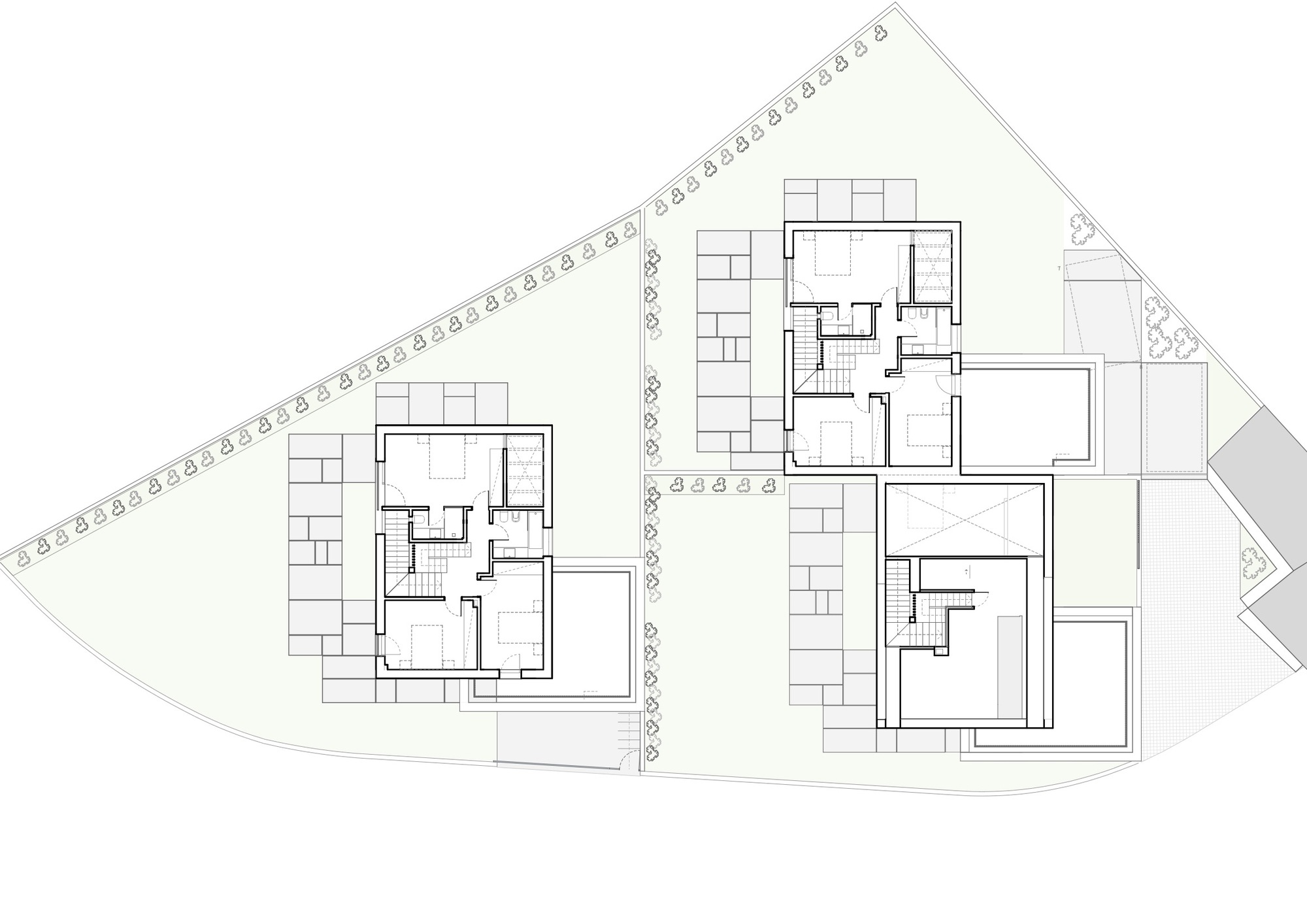 Floor plan drawing showing two residential units with central staircases and surrounding landscaping