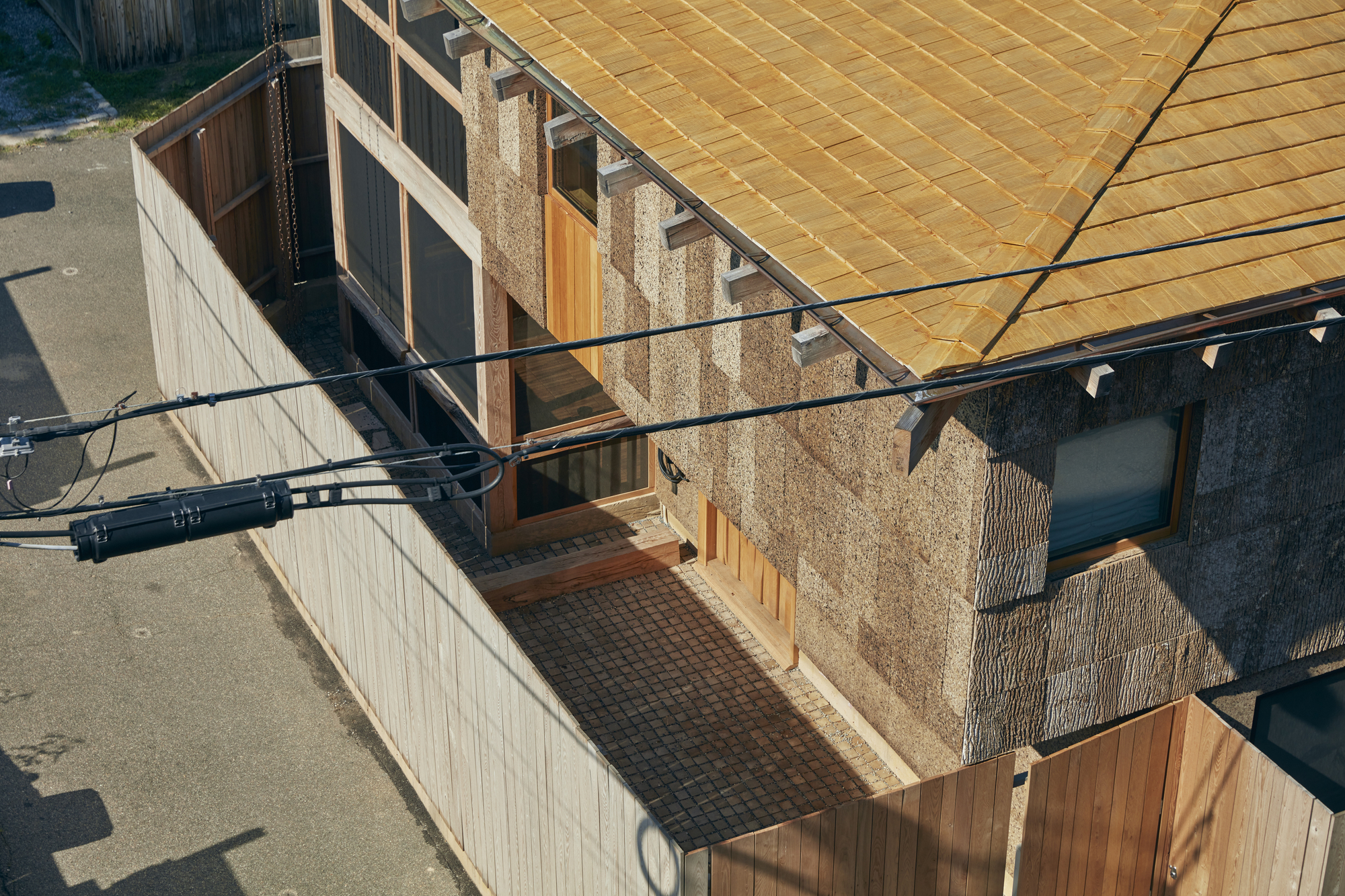 Close-up of the recessed entry with stone pilasters and timber roof structure from above
