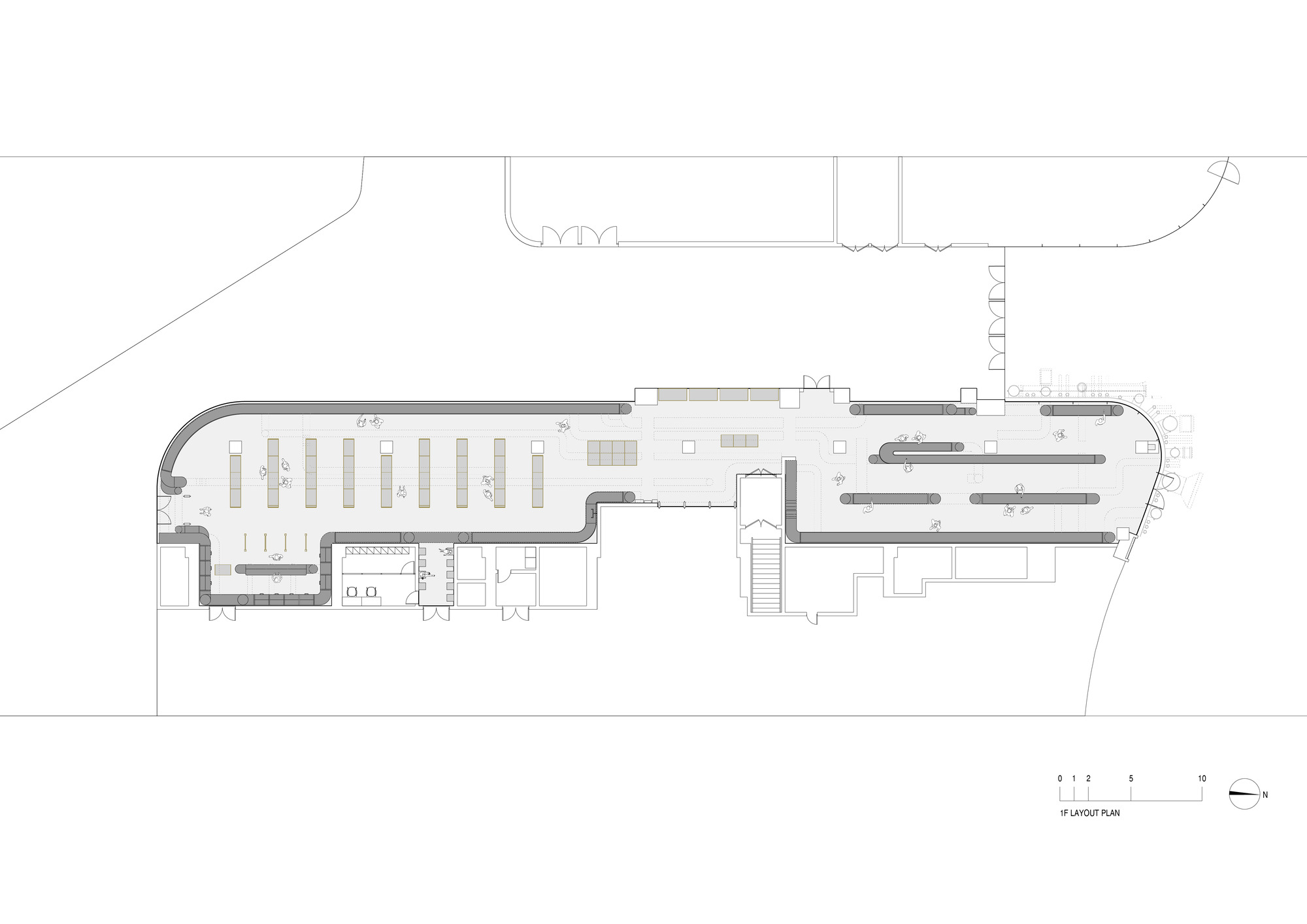 Floor plan drawing depicting a curved retail space with shelving layout and circulation paths