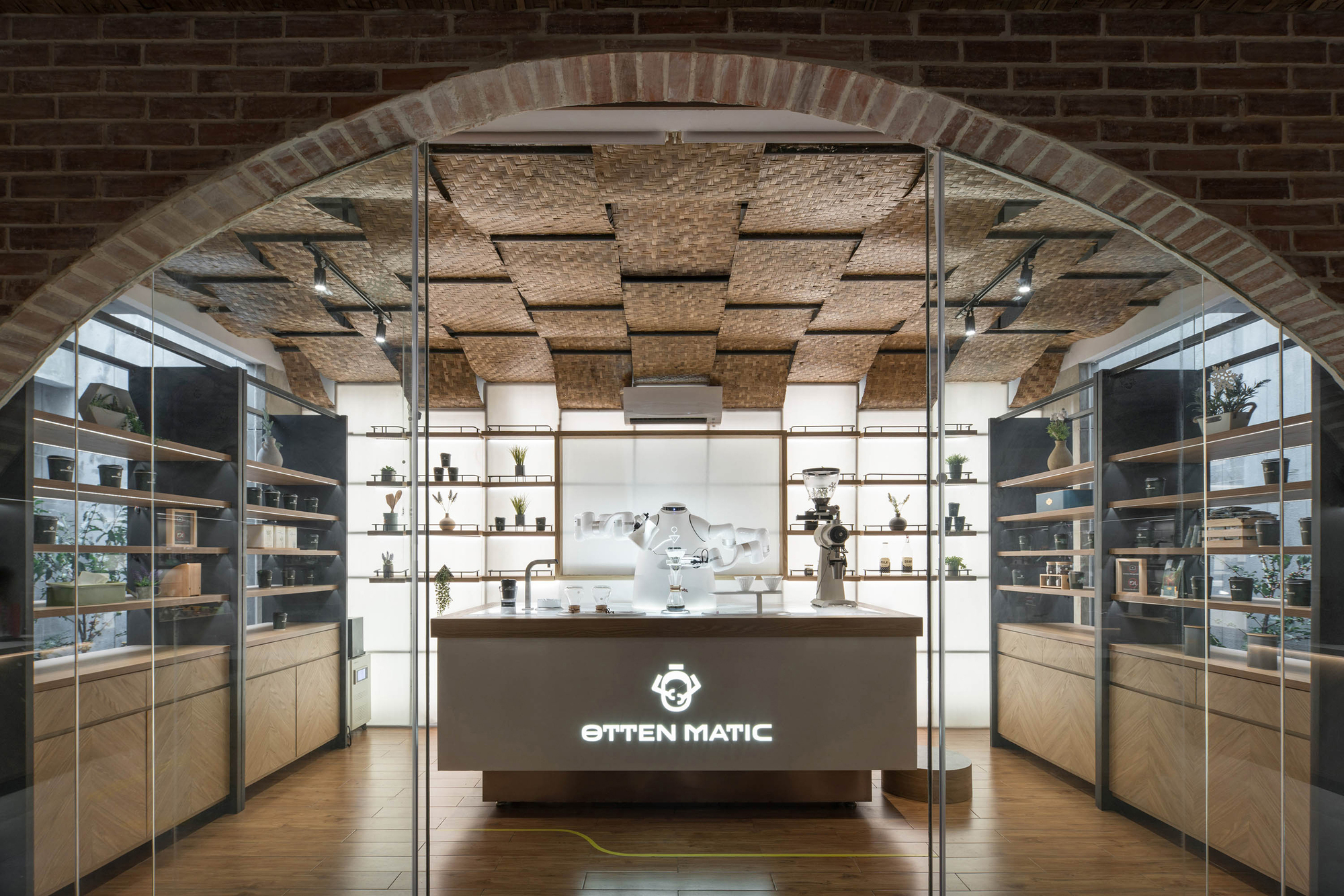 Coffee bar framed by brick arch with espresso machine centered beneath the woven ceiling treatment