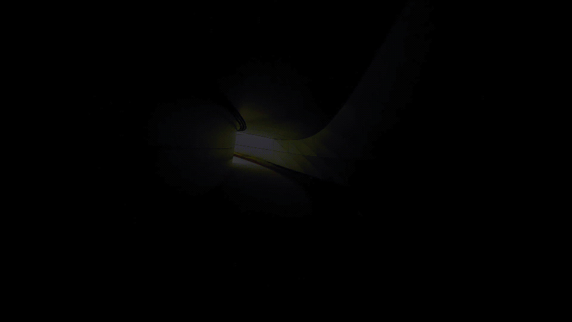 Narrow beam of light illuminating a person walking through a darkened corridor