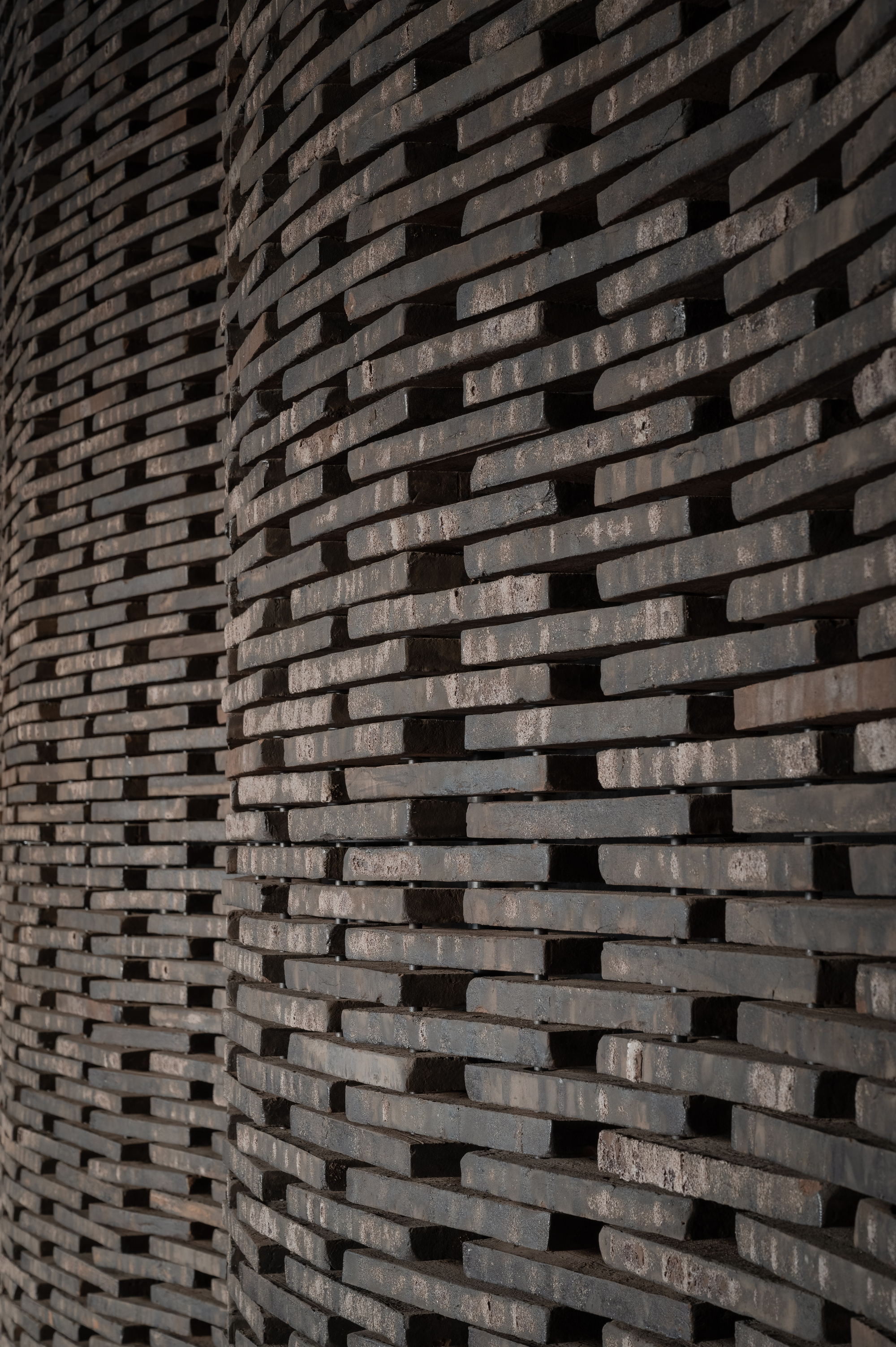 Close-up of textured brick wall with staggered courses creating a rhythmic pattern