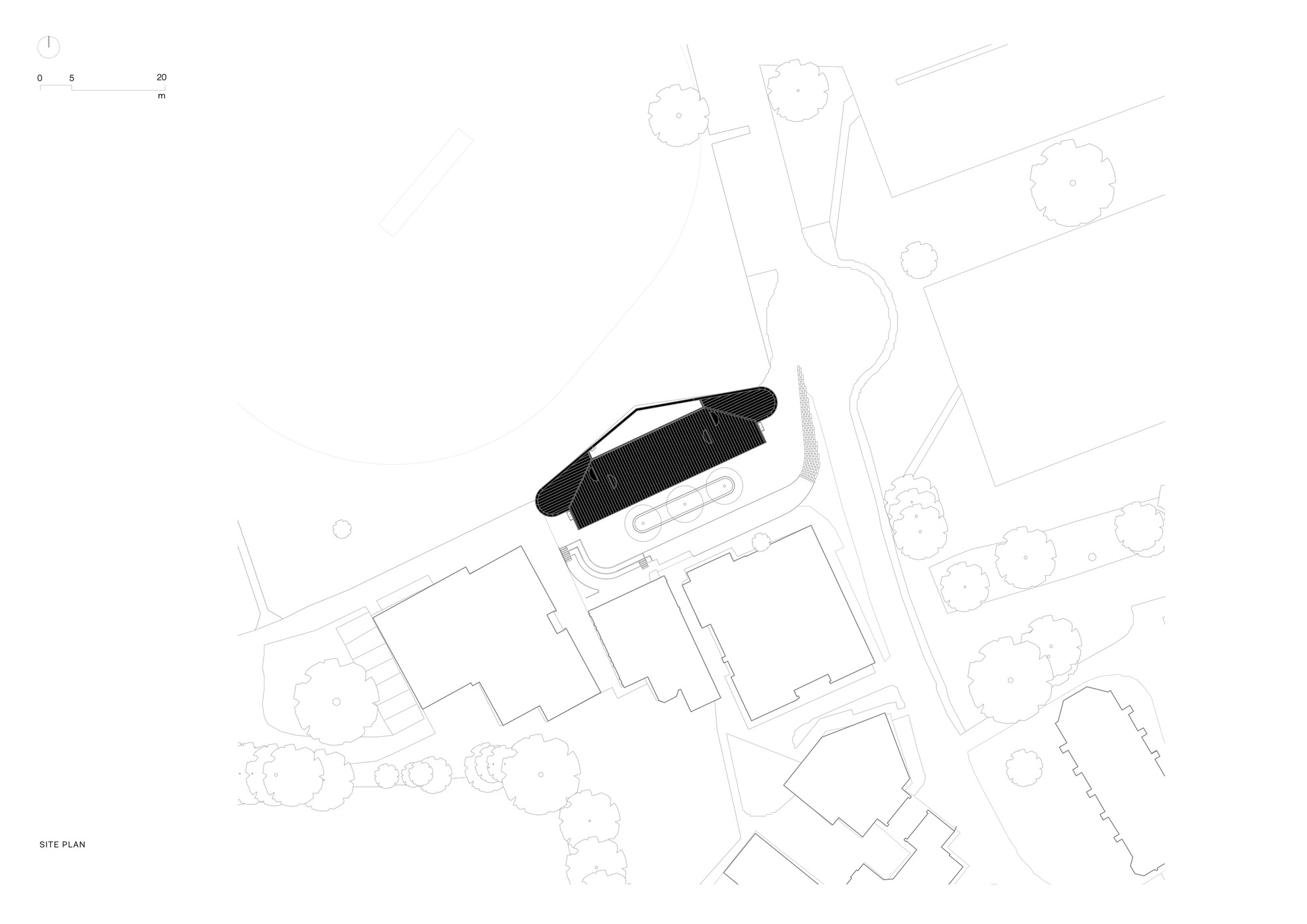 Site plan drawing showing the curved building footprint among surrounding structures and landscape