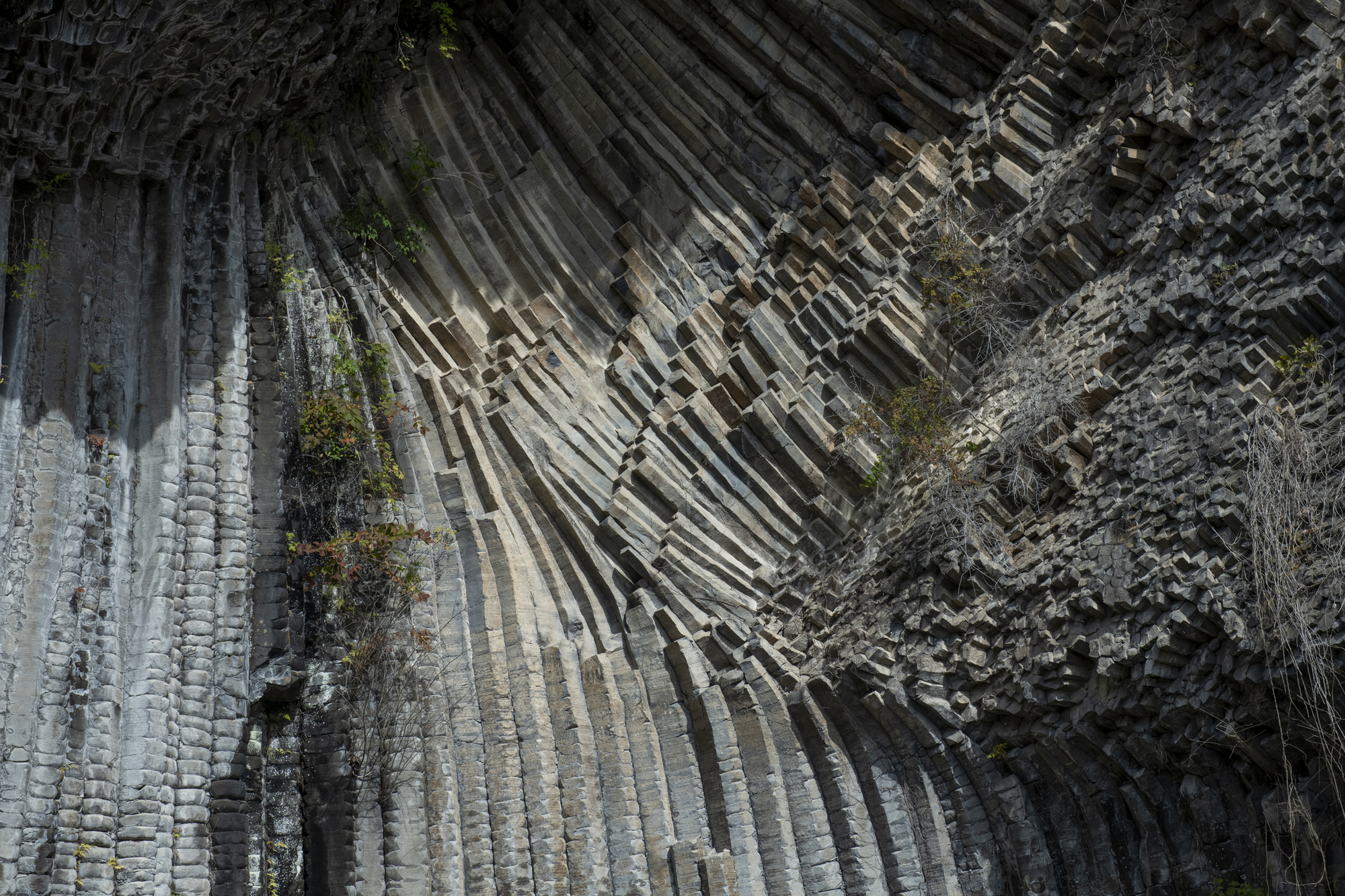 Overhead view of columnar basalt formations creating angular patterns across the rock face