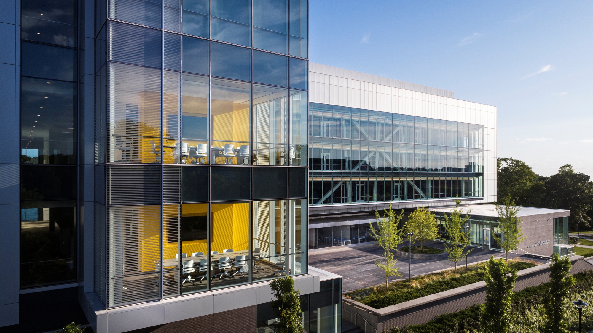 Corner view of the cantilevered upper floors with glass curtain wall and exposed diagonal steel bracing