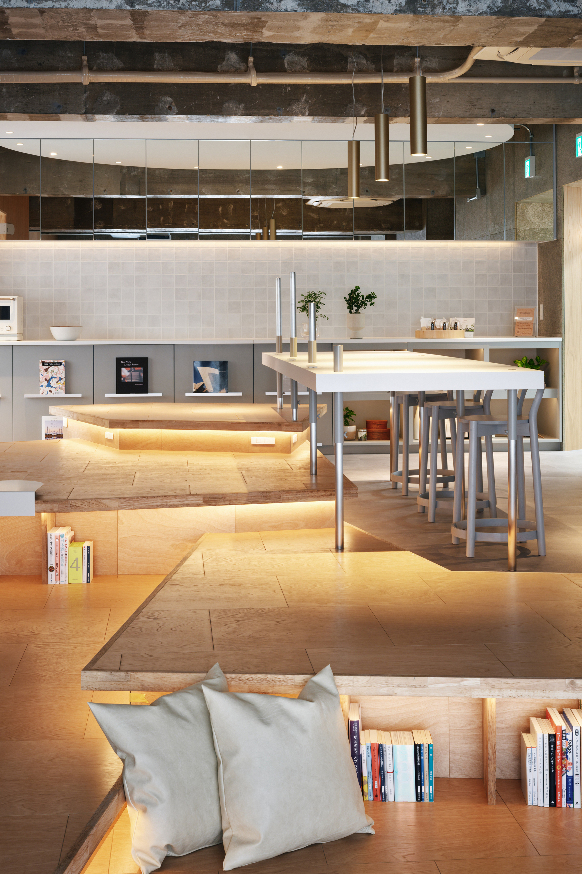 View across sunken lounge area toward kitchen counter with integrated LED strip lighting