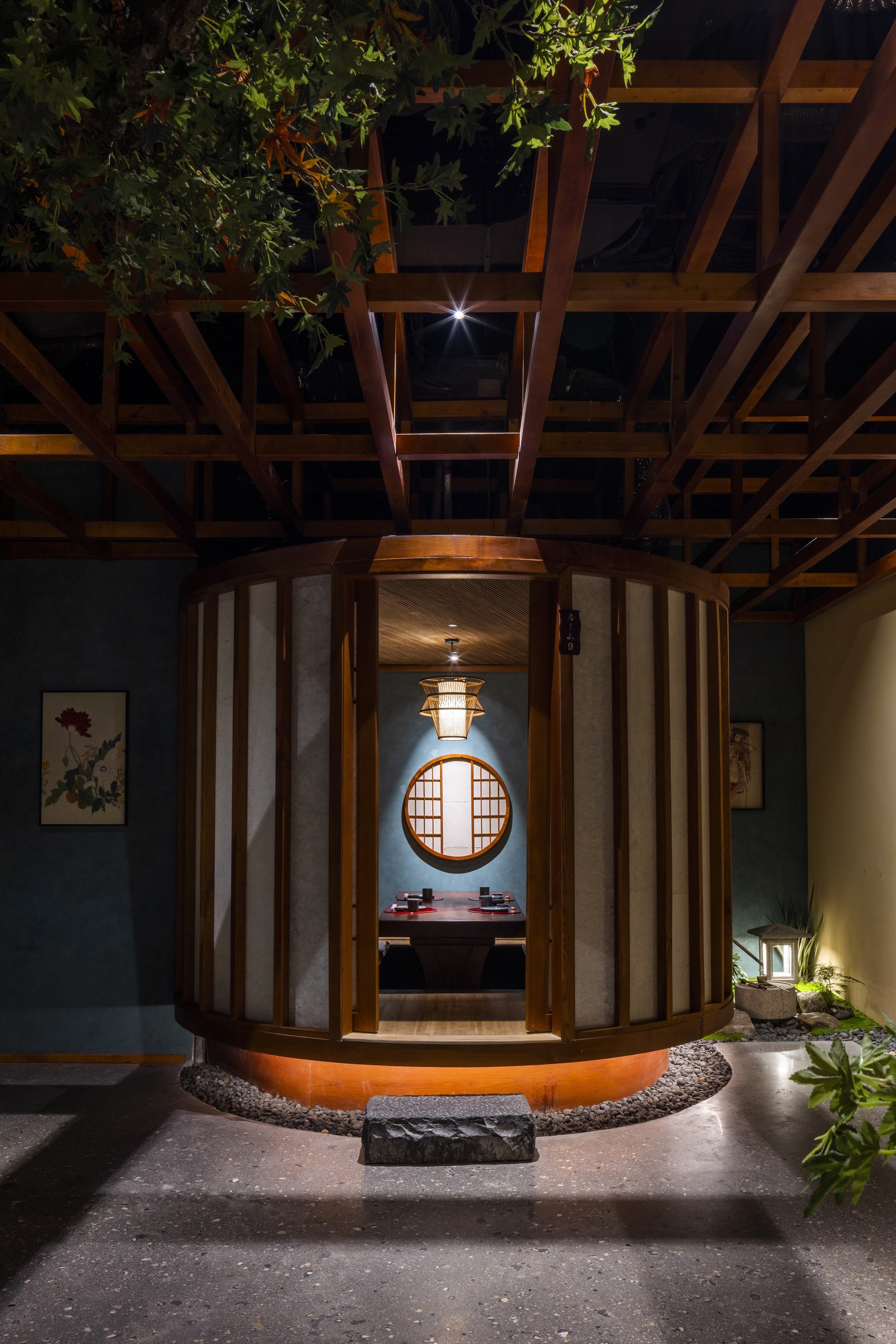 Interior view through the curved entry vestibule showing a circular window and pendant light in the foyer beyond