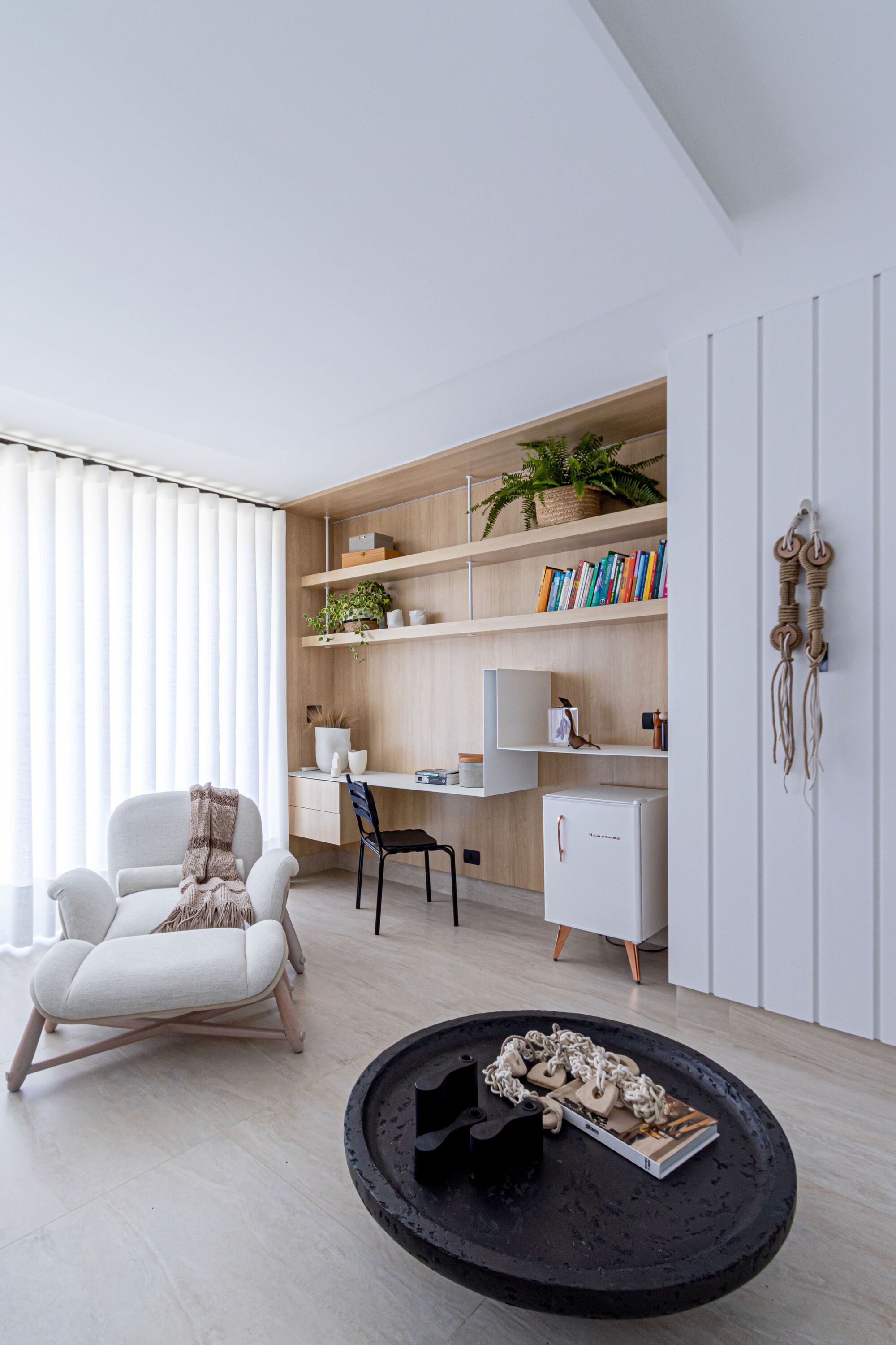 Home office nook with built-in timber shelving and vertical white panel wall