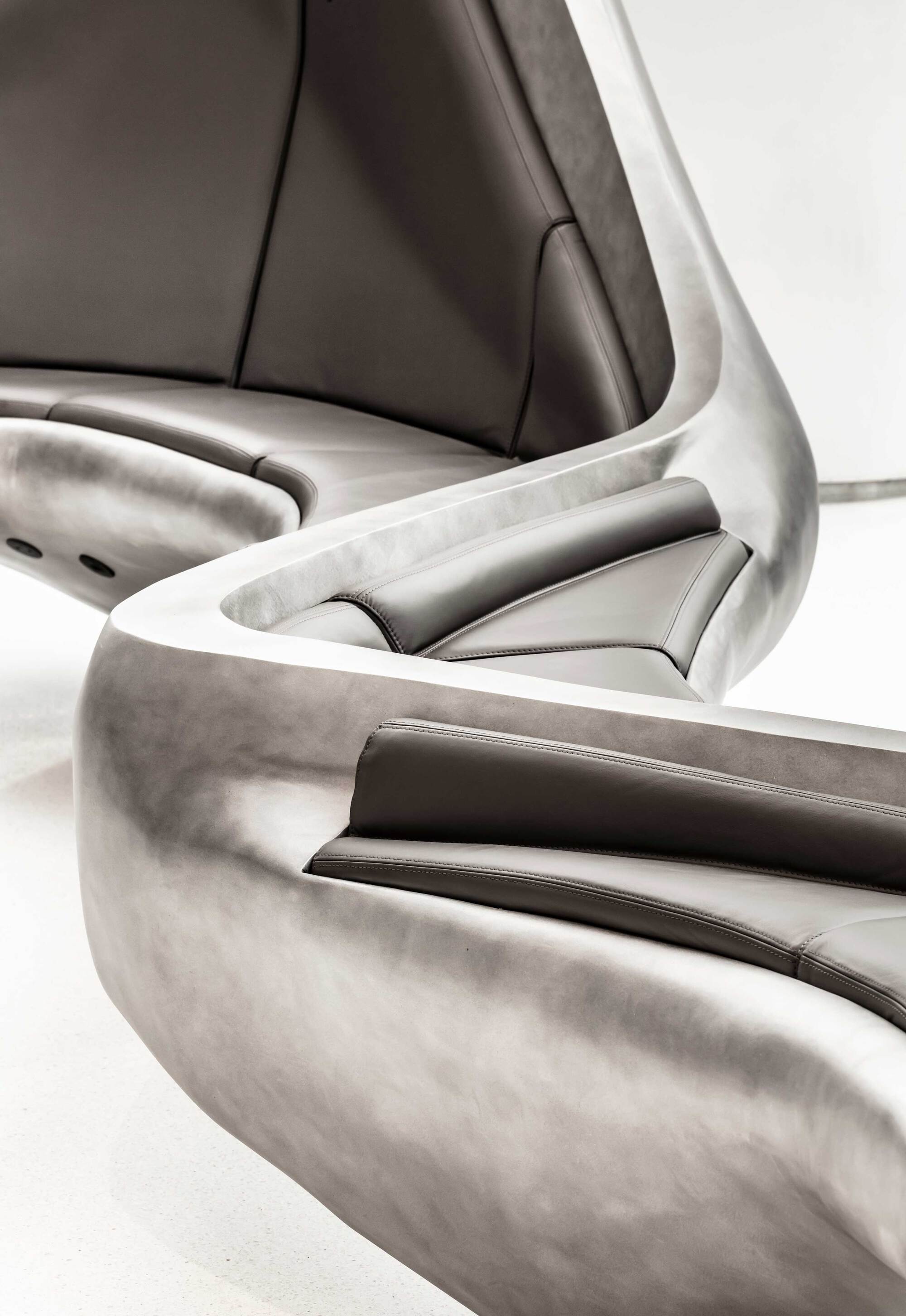 Close-up of leather-upholstered seating with curved metallic frame details