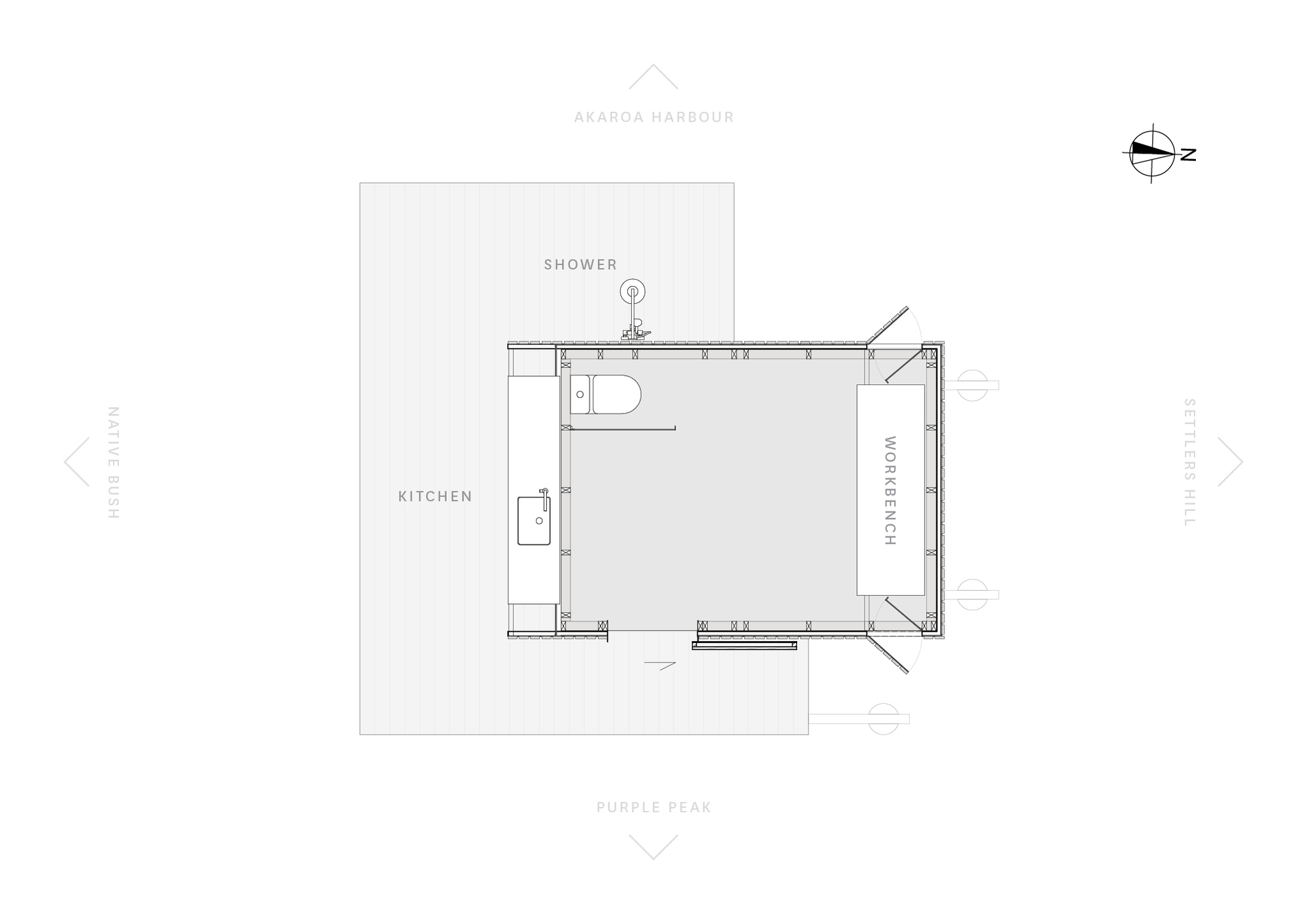 Floor plan drawing showing a compact layout with shower, kitchen, and workspace around a central room