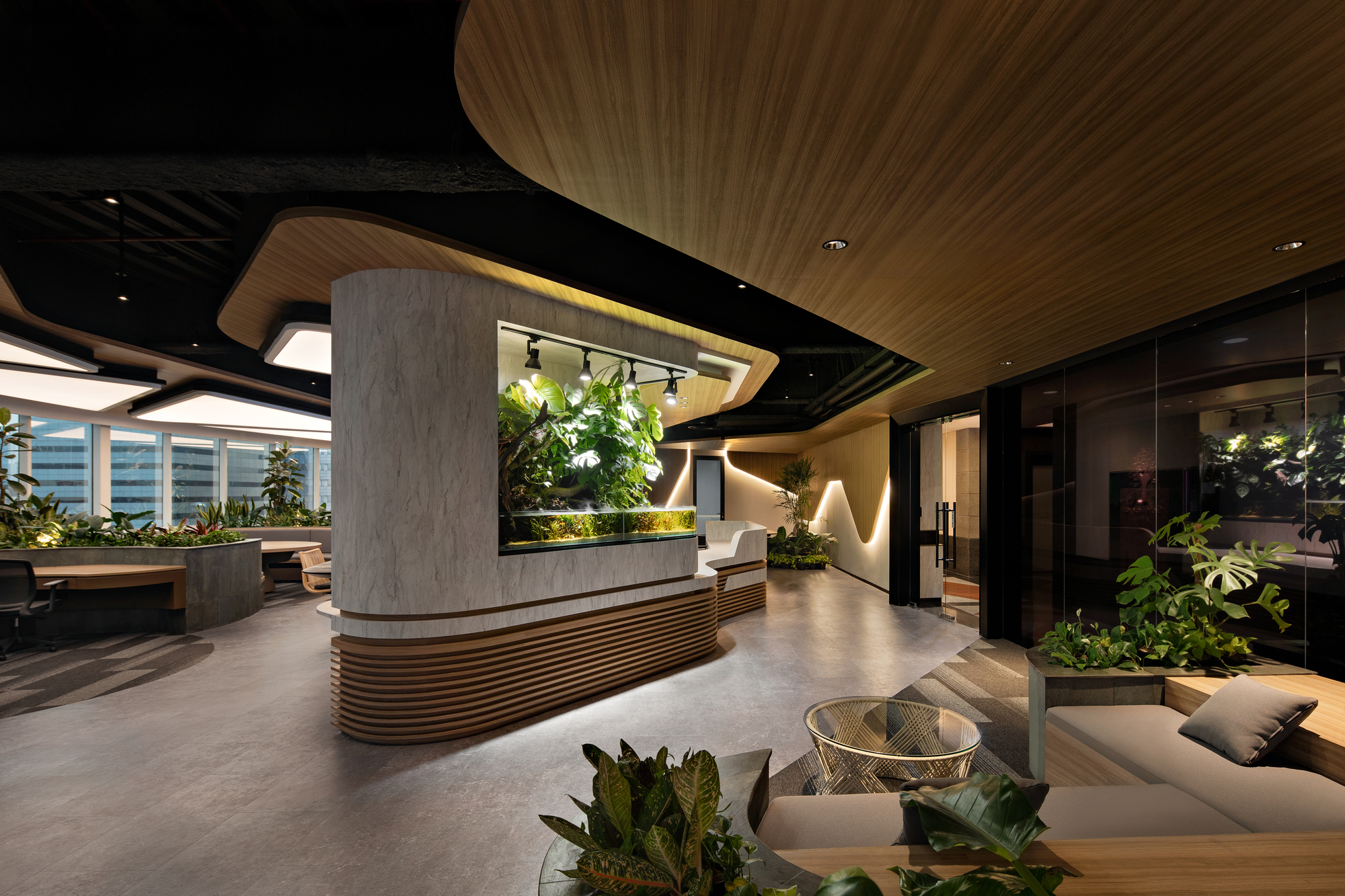 Reception desk with concrete and wood slat base beneath a curved timber ceiling with integrated planters