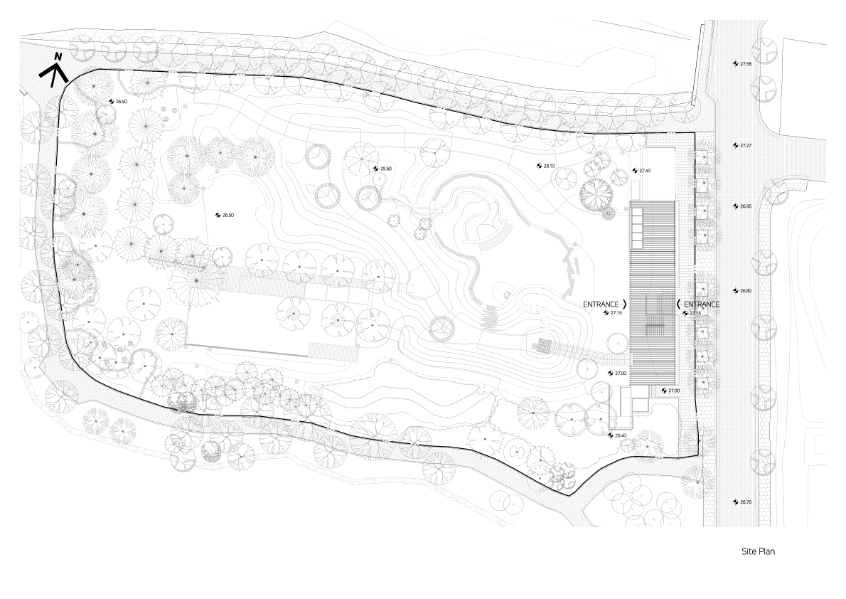 Site plan drawing showing the linear structure alongside curved pathways and landscaped topography
