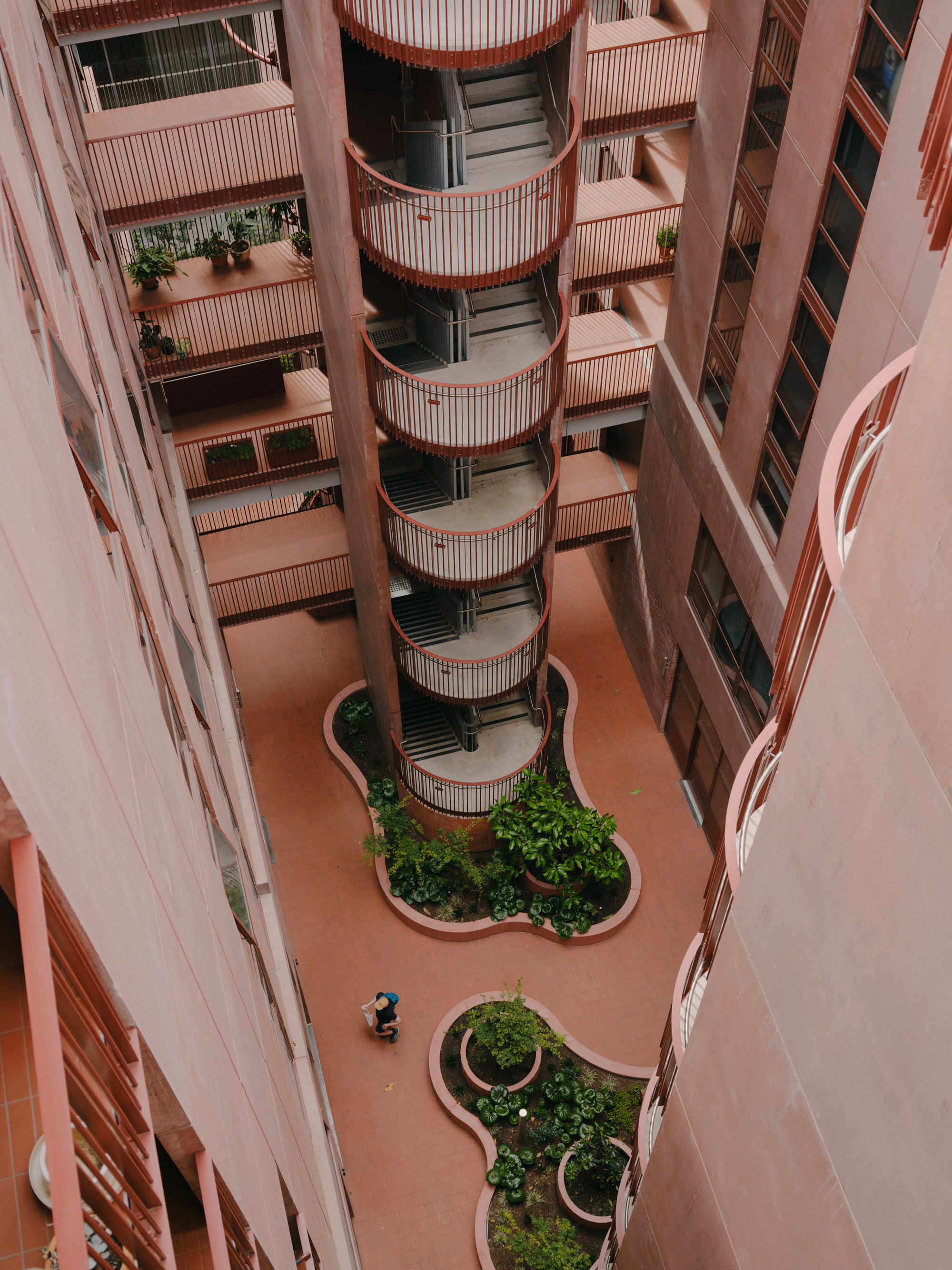 Looking down into the internal courtyard with curved planting beds and cylindrical balcony tower