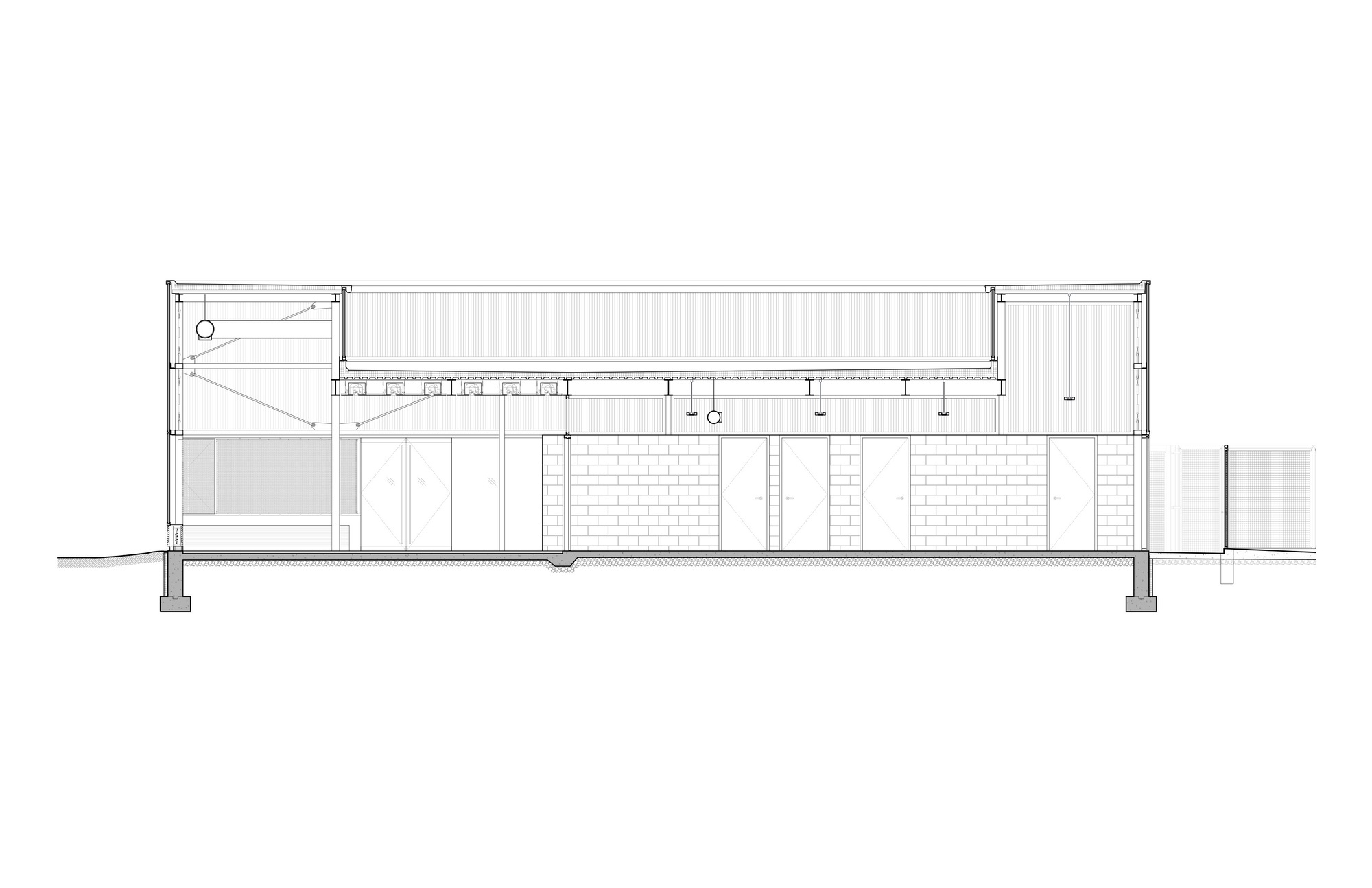 Building section drawing showing the single-story structure with exposed roof trusses and clerestory glazing