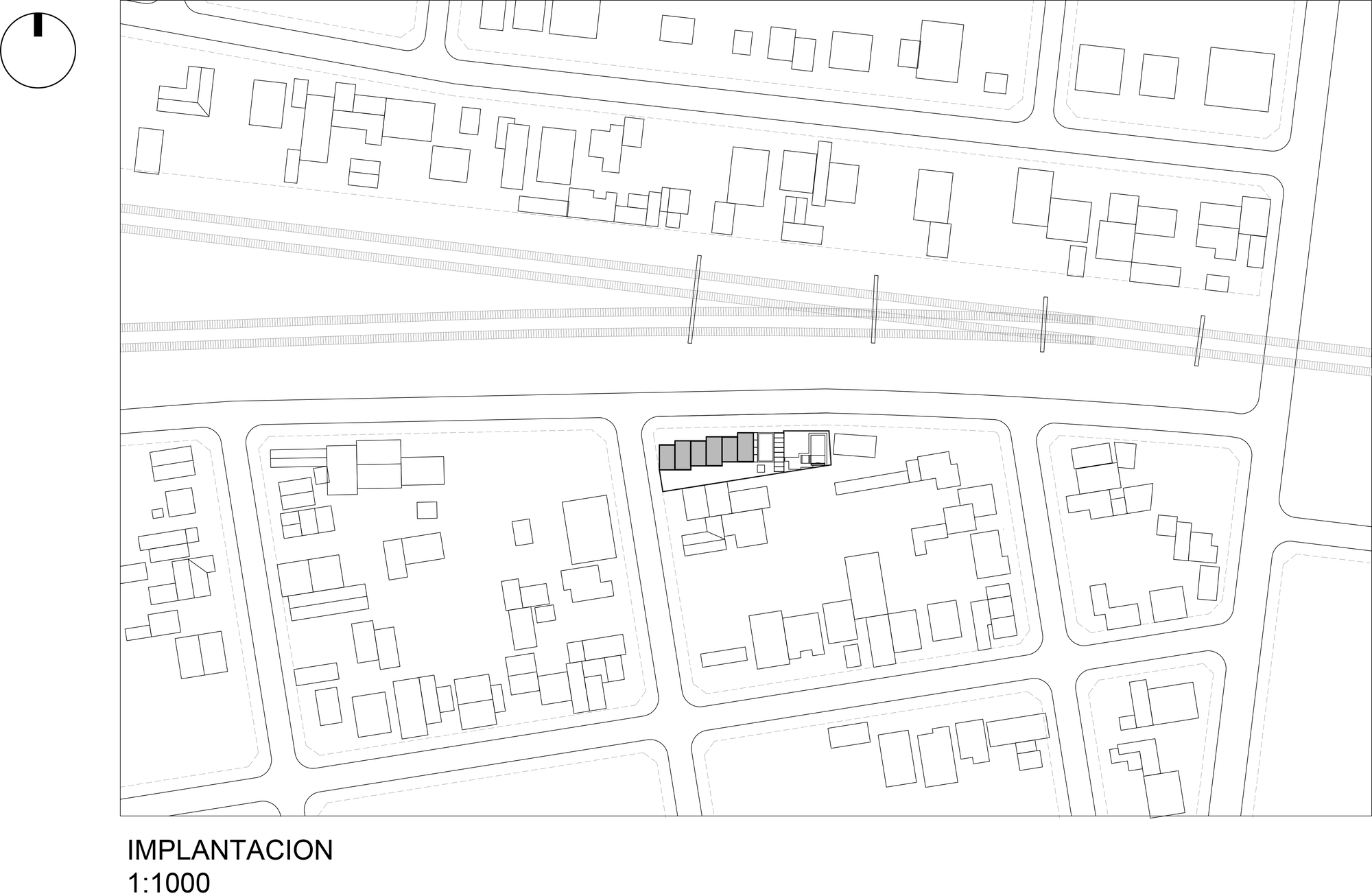 Site plan drawing showing building footprints within urban blocks bisected by a rail corridor
