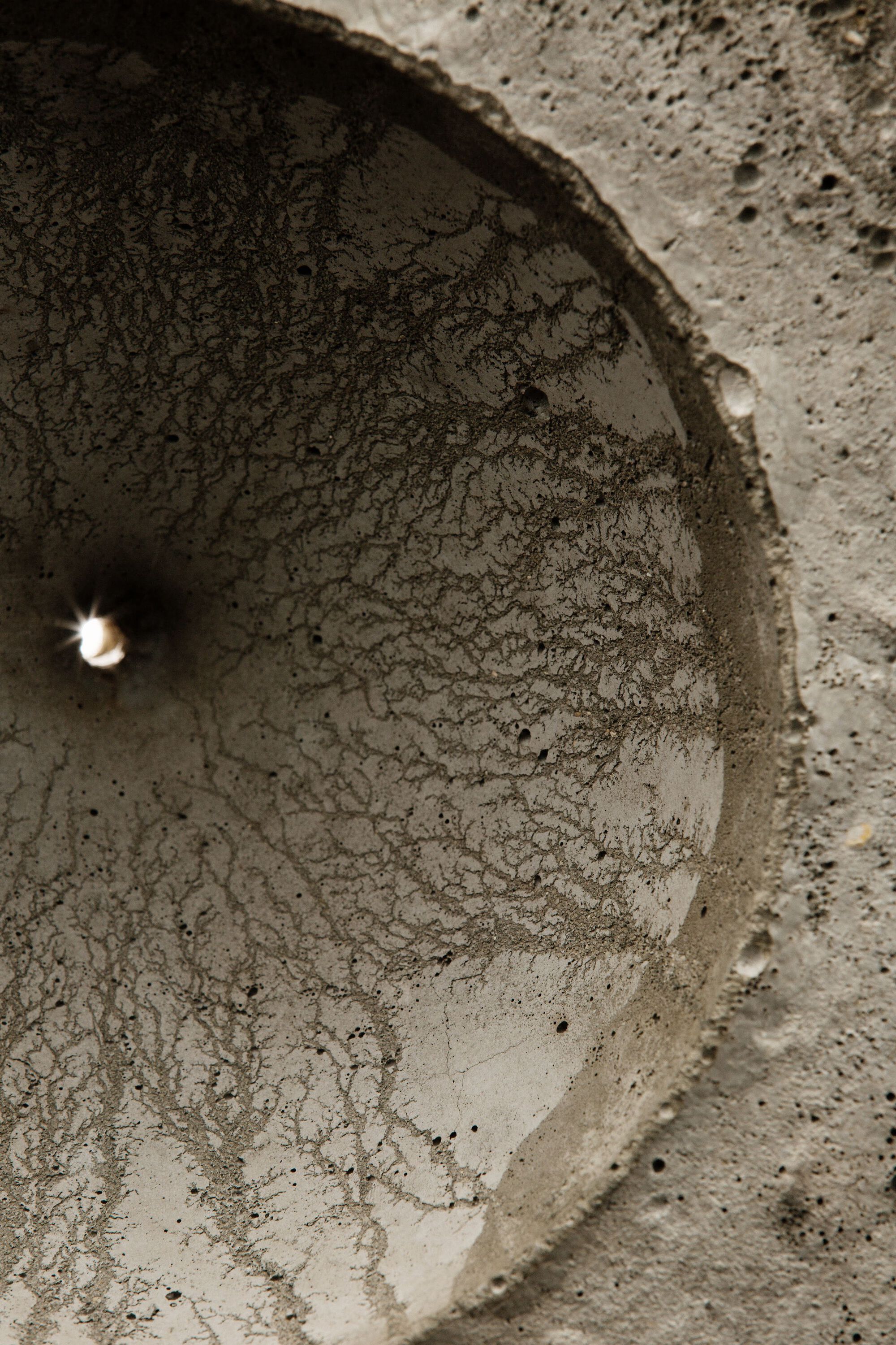 Interior view looking up into one of the curved concrete voids with textured surface