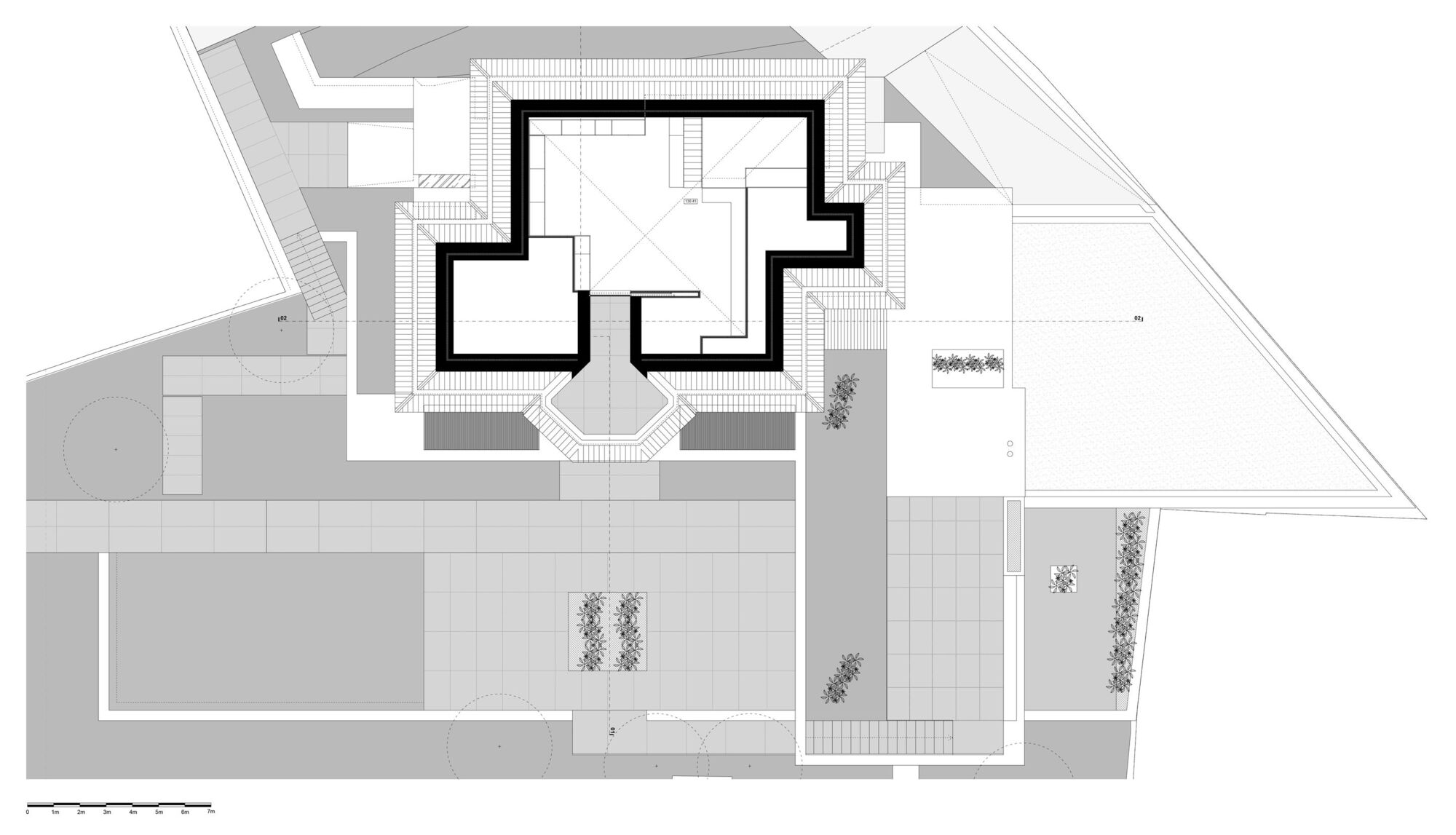 Roof plan drawing showing the central building volume with stepped massing and surrounding landscape areas