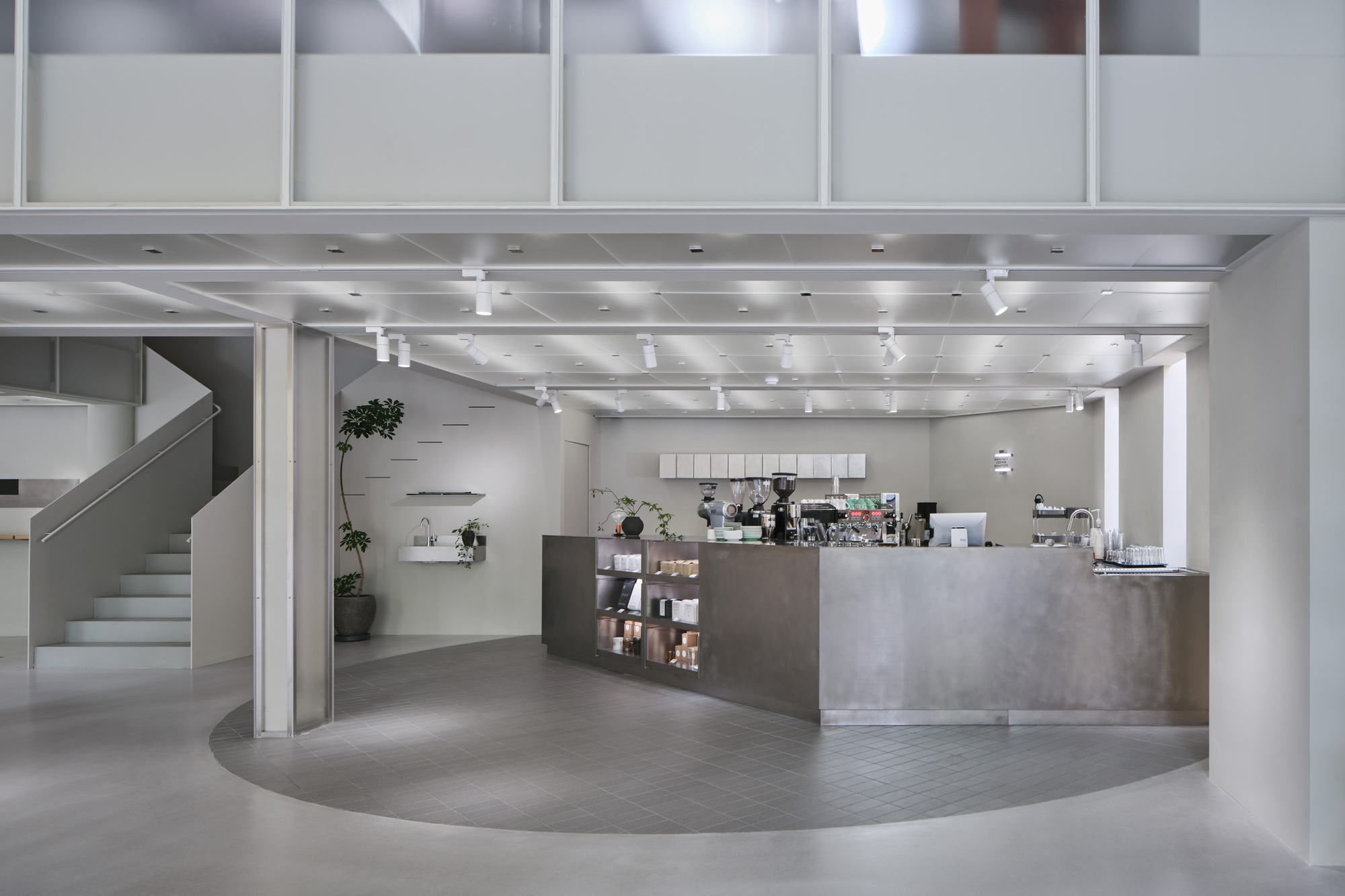 View of the cafe counter with exposed metal ductwork and track lighting overhead