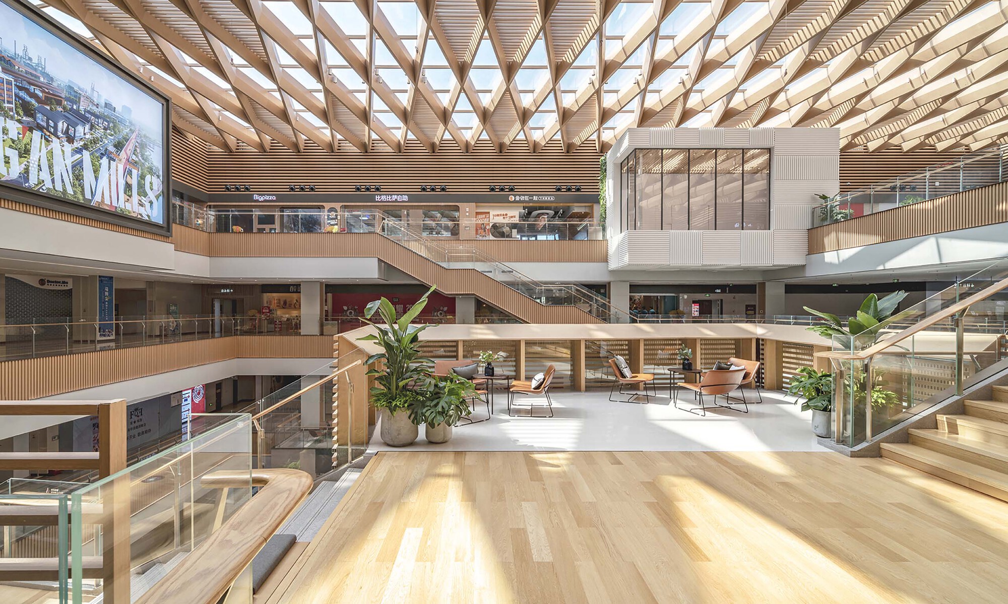 Multi-story atrium with timber lattice ceiling, interconnected walkways, potted plants and timber floor terraces