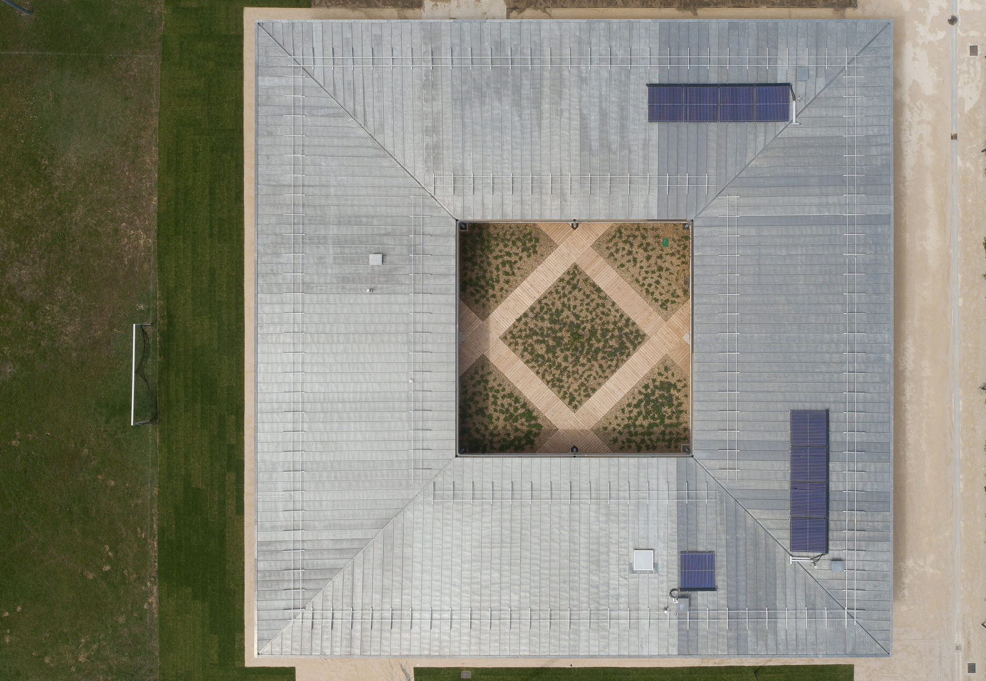 Aerial view of the tiled roof with central courtyard planted in a diagonal grid pattern