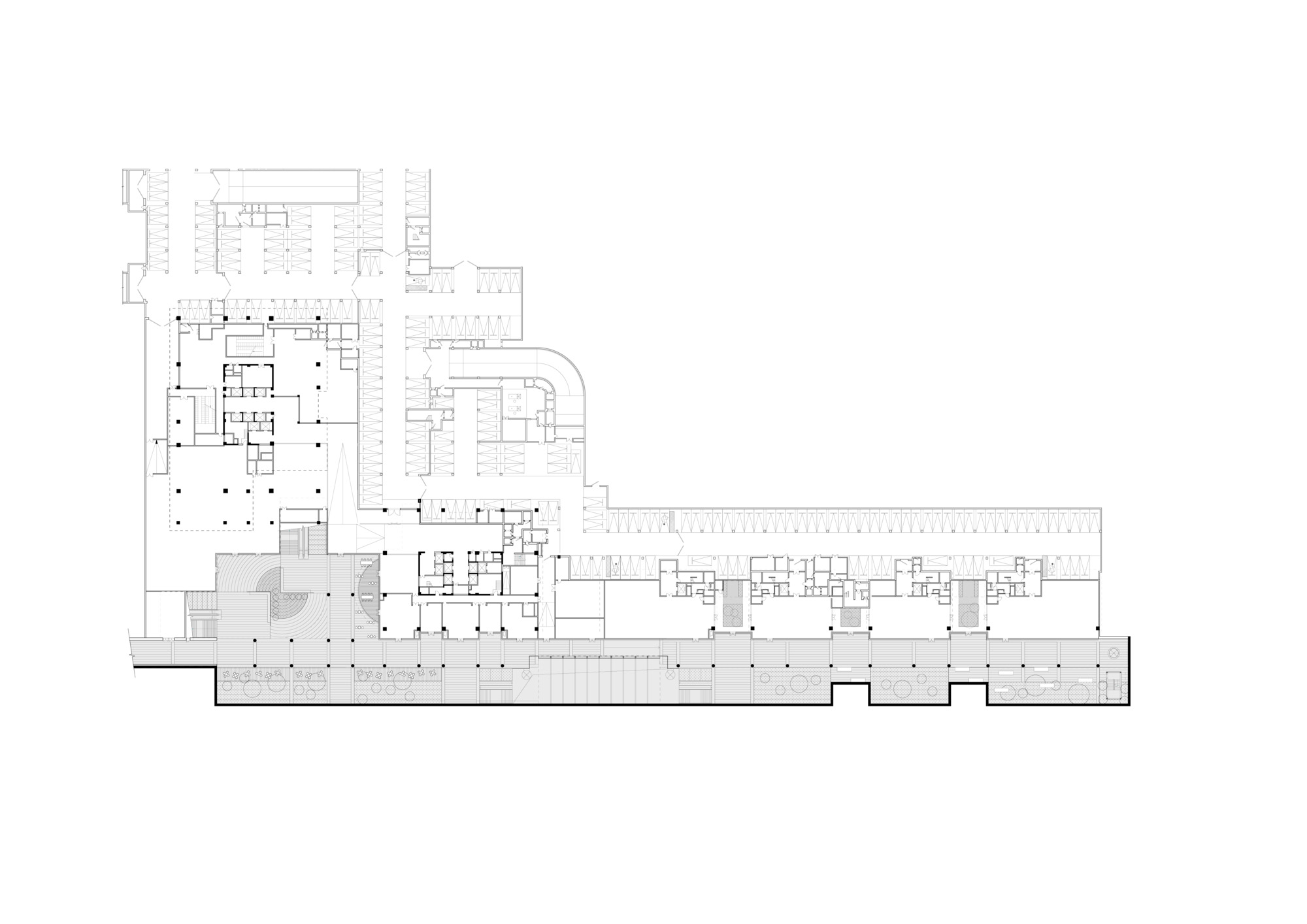 Floor plan drawing showing an irregular L-shaped layout with columnar grid and extended wing
