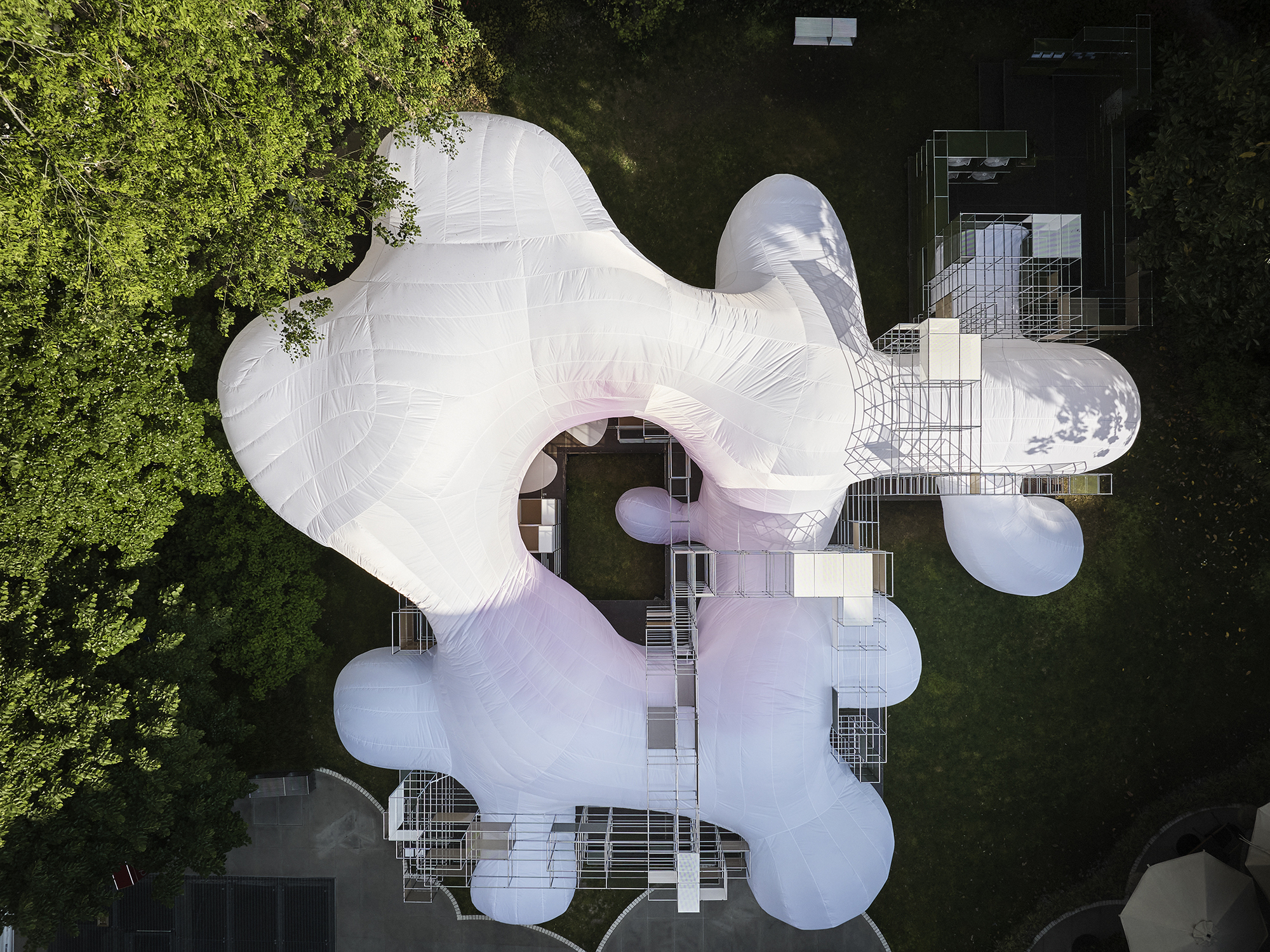 Aerial view of the white inflated membrane roof with bulbous lobes nestled among surrounding trees and buildings