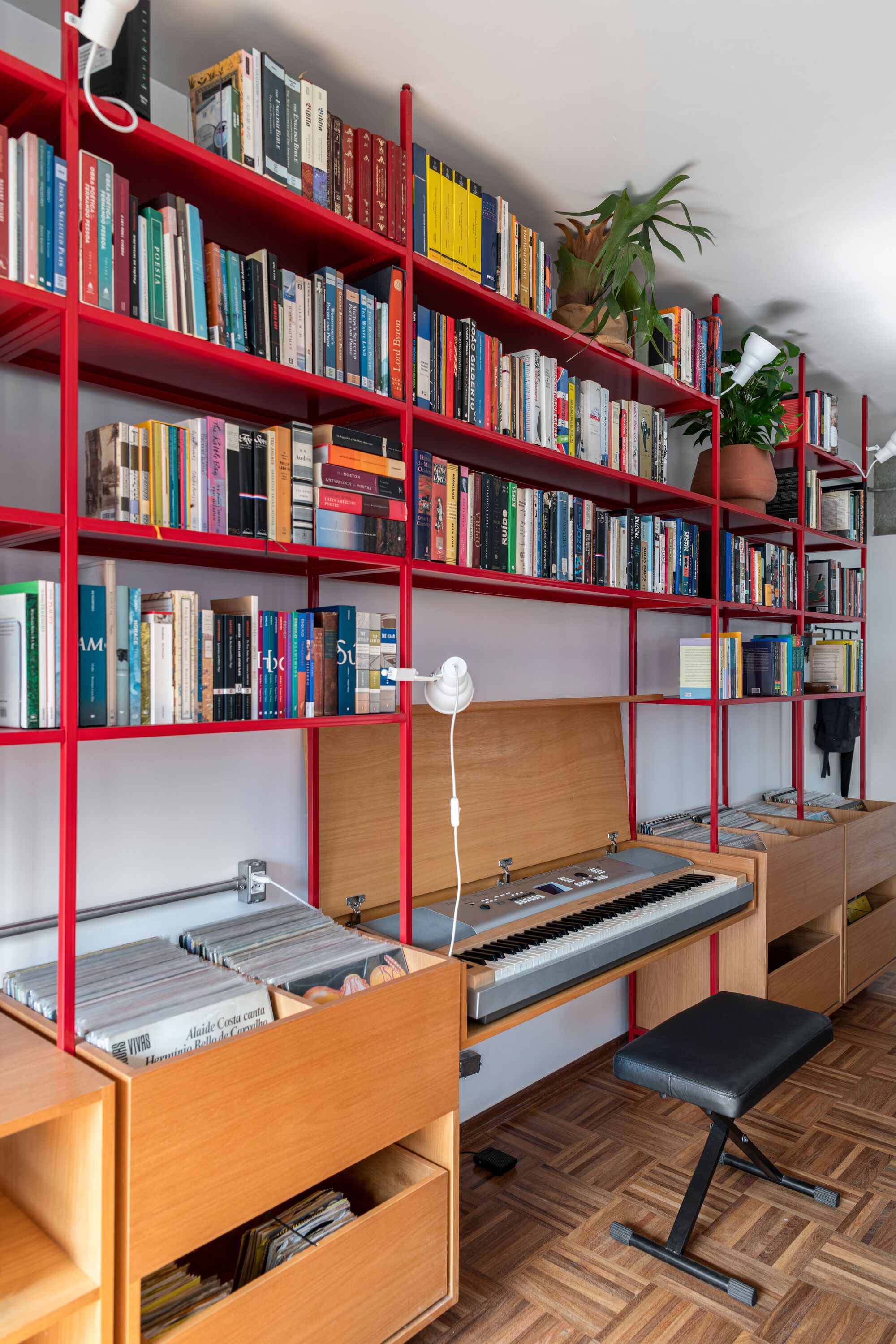 Red steel shelving unit with pull-out keyboard drawer and timber storage compartments below