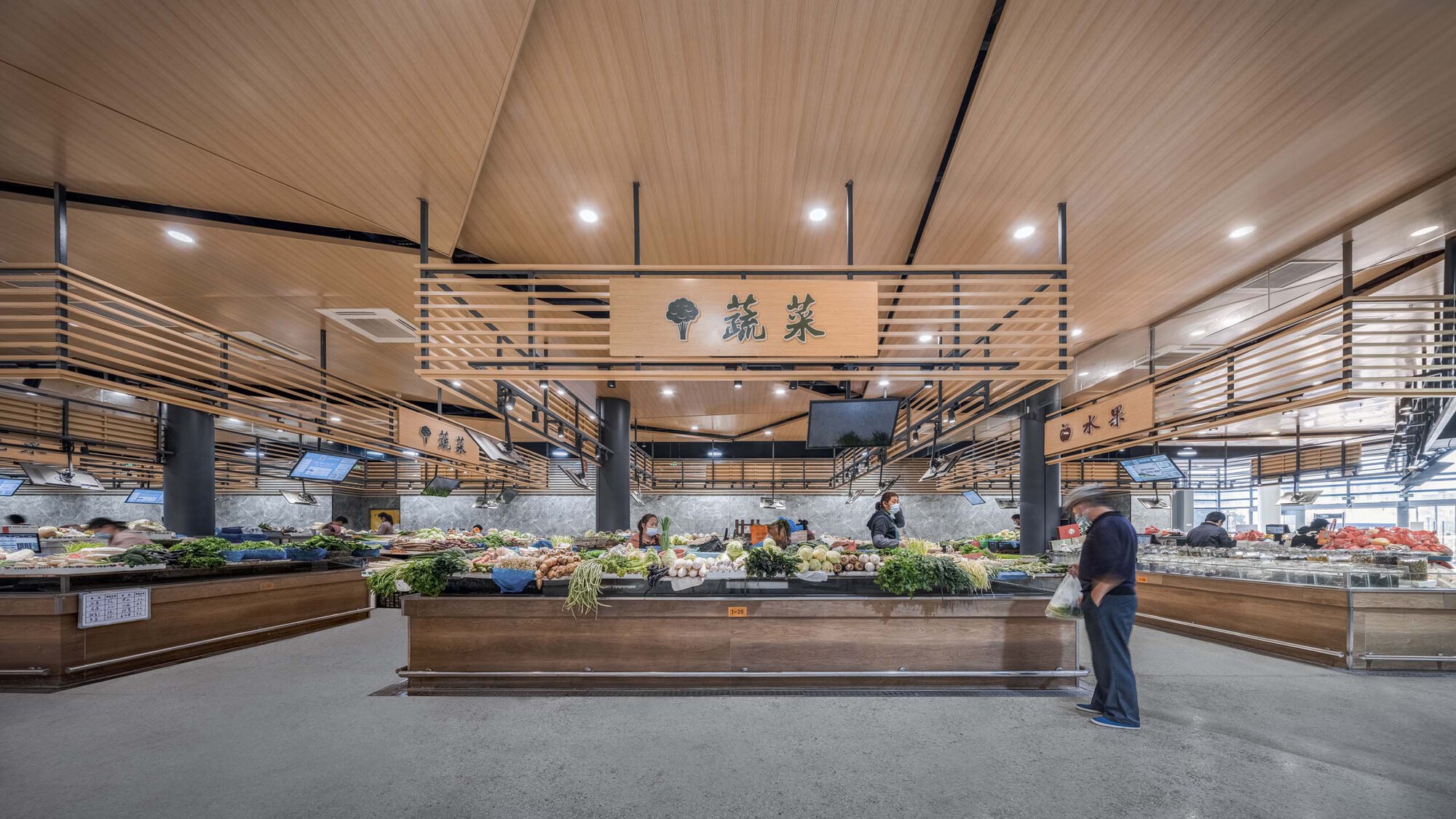 Market hall interior with timber slatted ceiling, black columns and produce displays with shopper