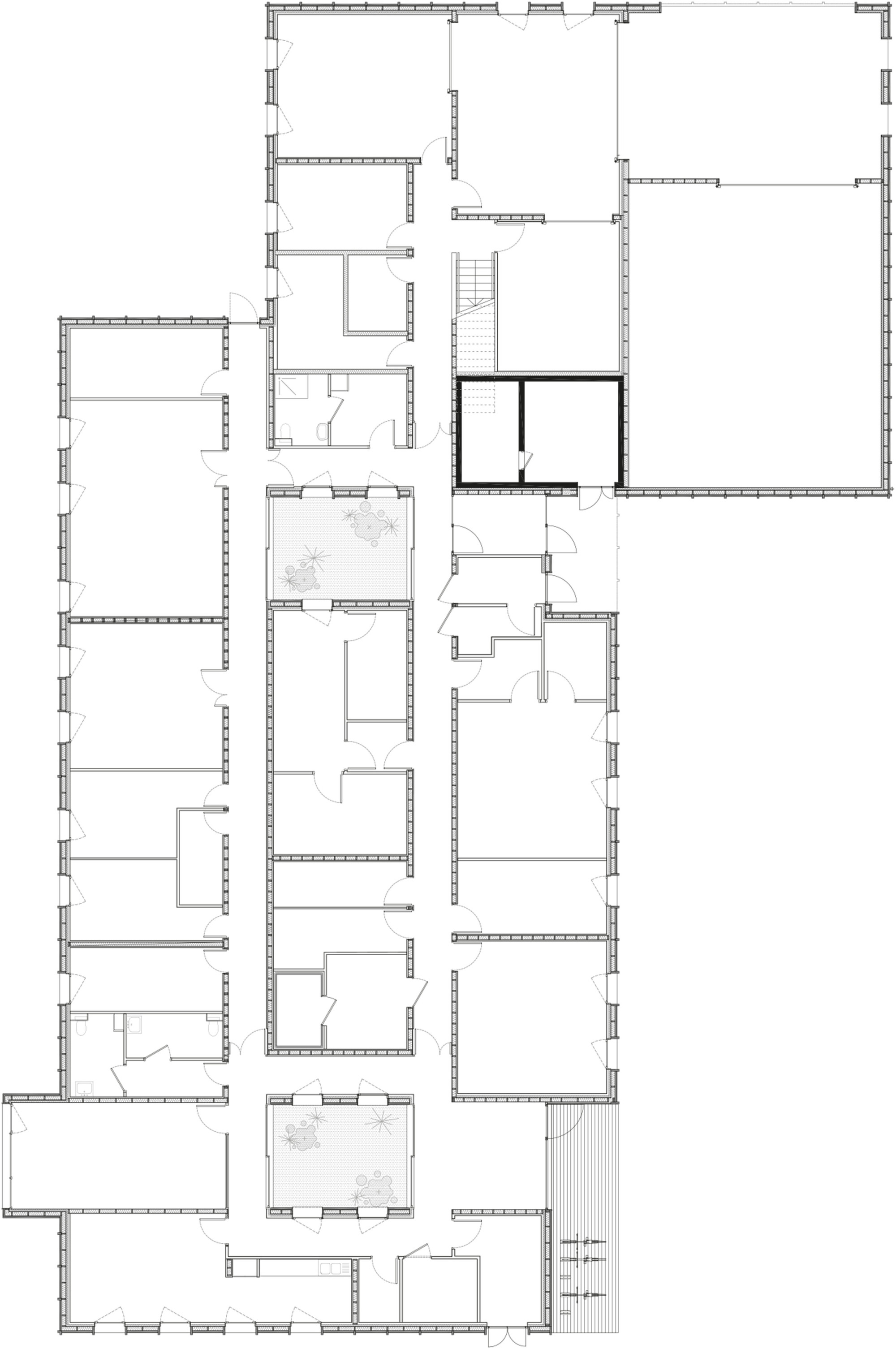 Floor plan drawing depicting multiple rooms and circulation spaces arranged around a central stairwell