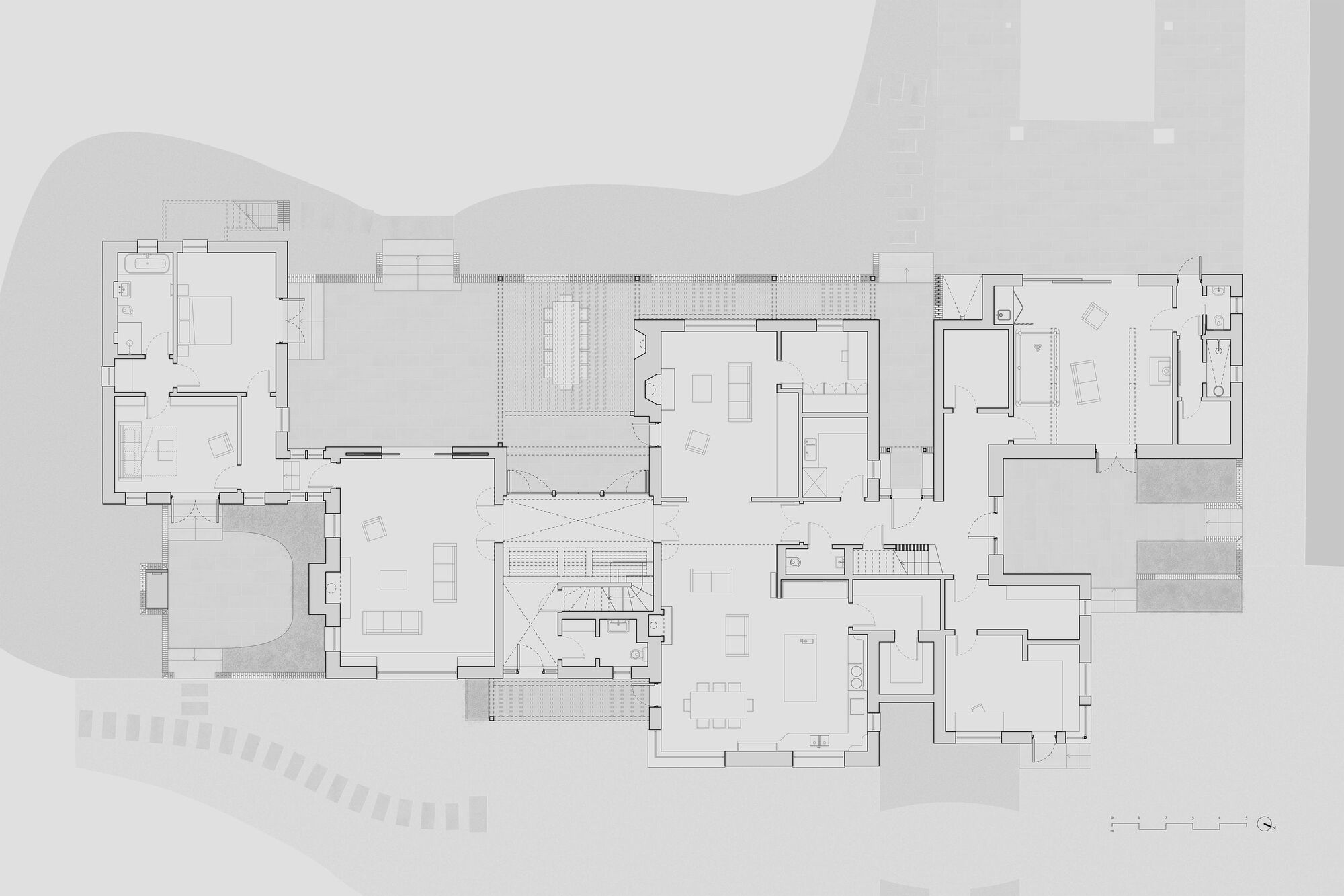 Floor plan drawing showing interconnected rooms arranged around central courtyard with surrounding landscape