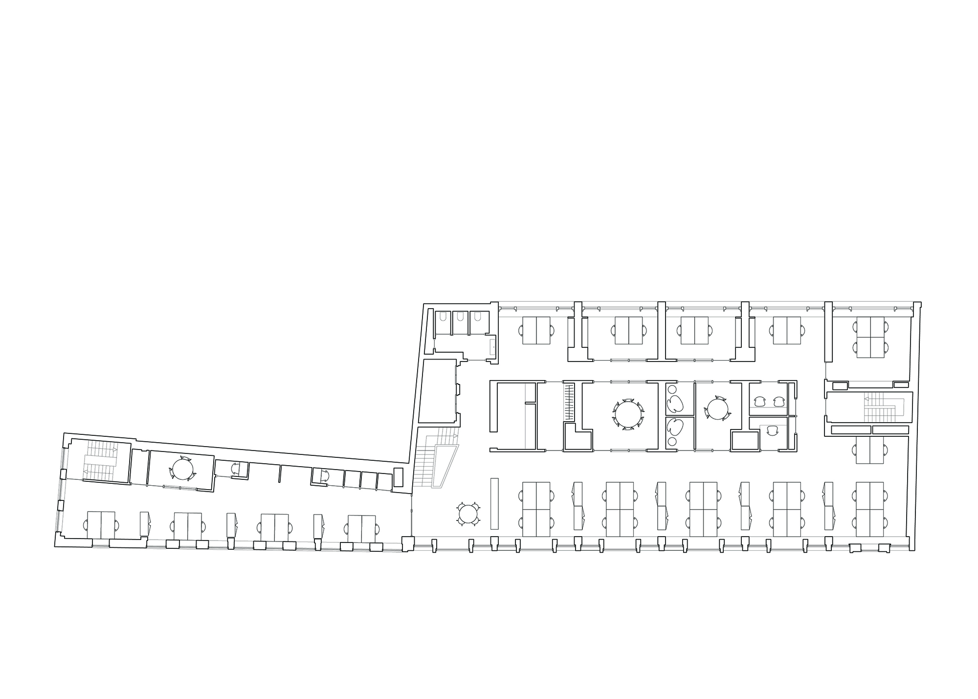 Floor plan drawing showing an L-shaped layout with rows of workstations and meeting rooms