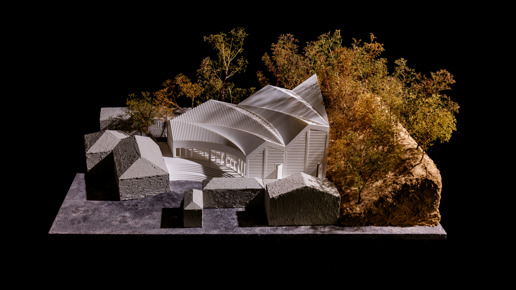 Physical model showing the undulating roof forms with surrounding context buildings and trees