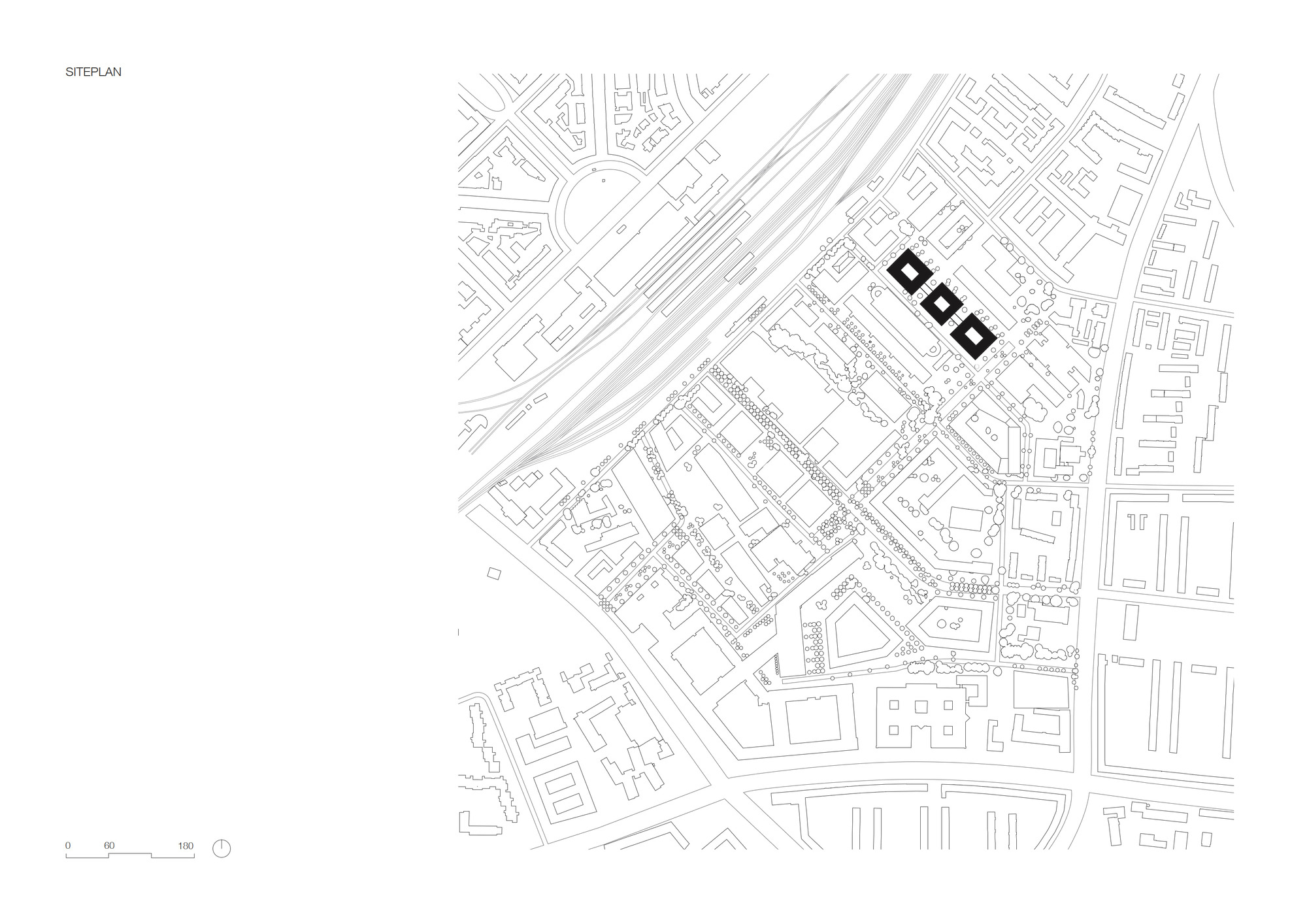Site plan drawing showing three rectangular volumes adjacent to diagonal railway tracks and surrounding urban blocks