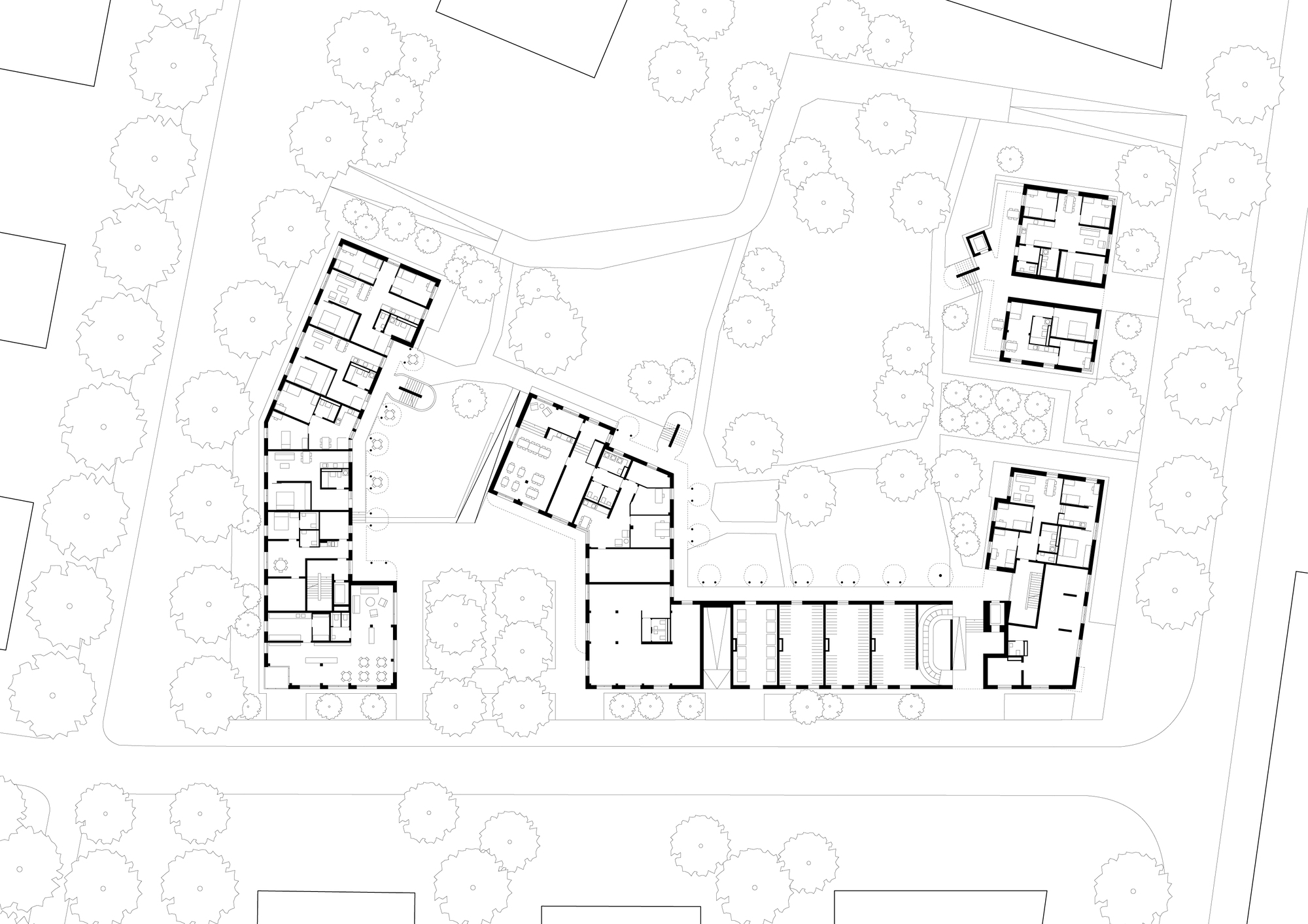 Ground floor plan showing residential wings with central corridor and surrounding mature trees