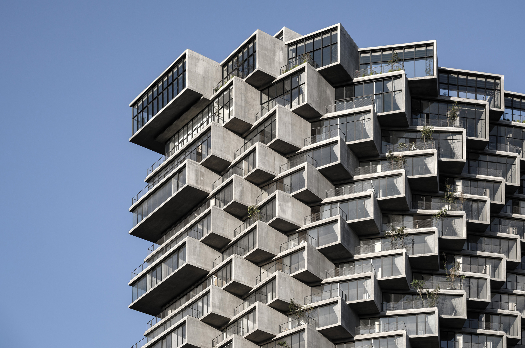 Close-up of the cantilevered concrete balconies and floor plates stacked in alternating layers