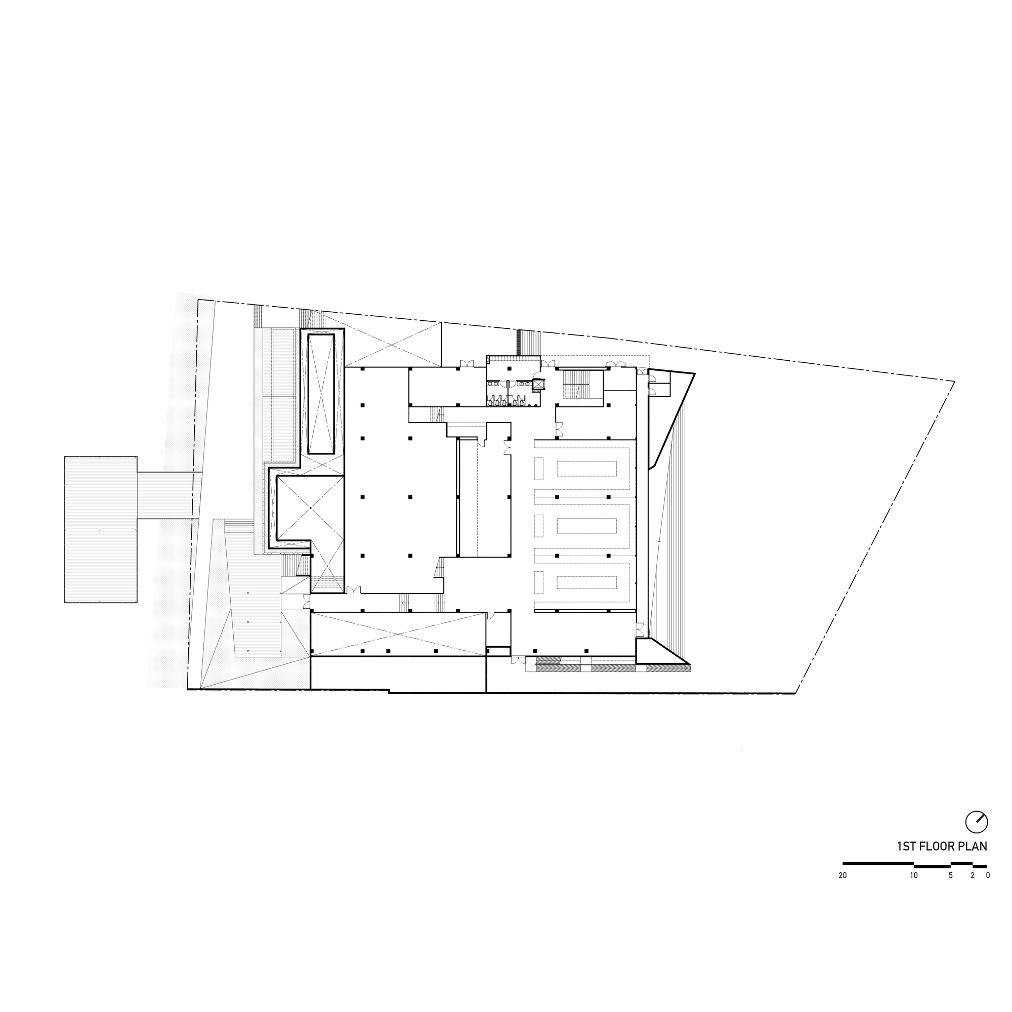 First floor plan drawing showing trapezoid site with central courtyard and perimeter support spaces
