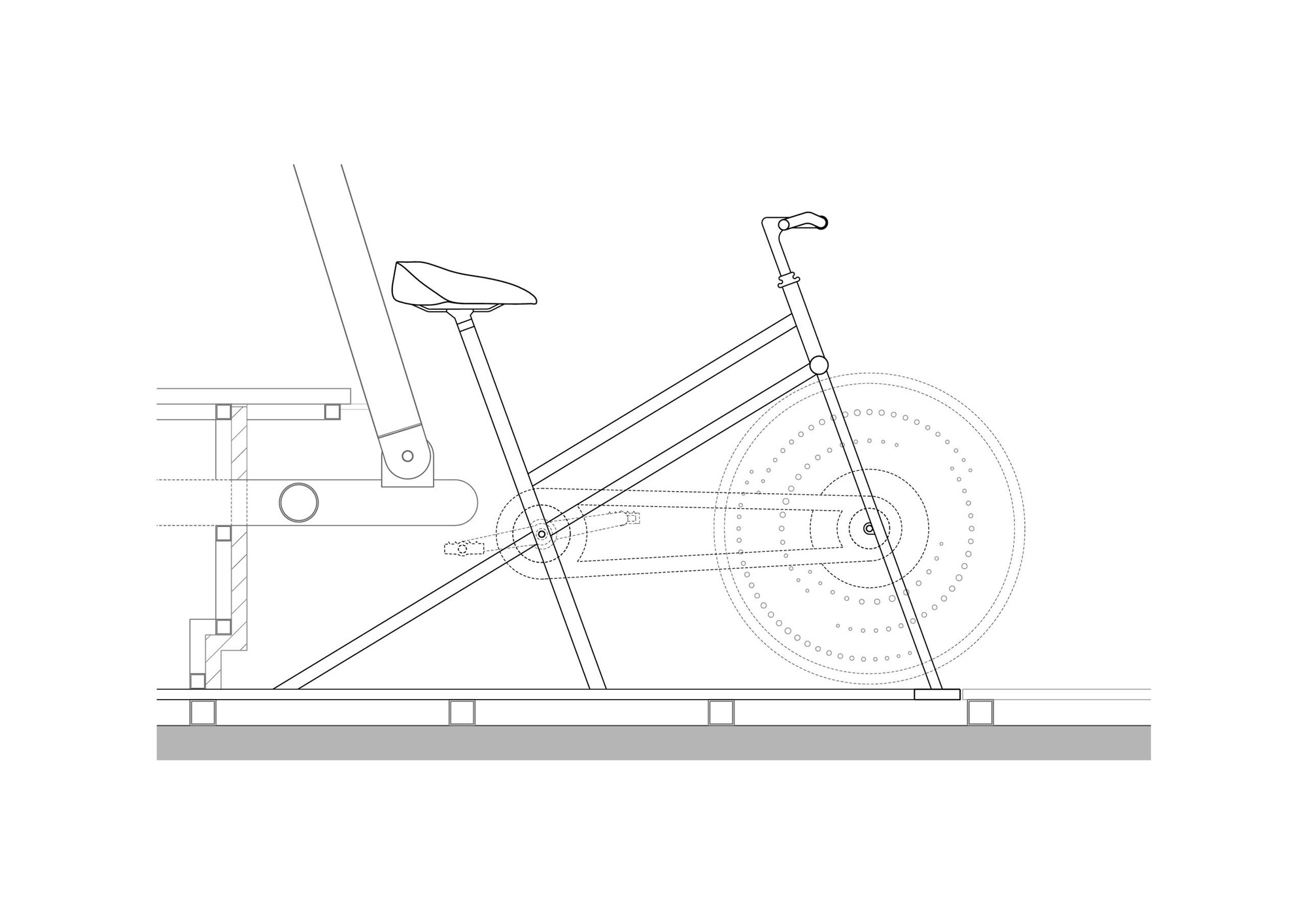 Section drawing detailing a stationary bicycle mounted on an angled frame with resistance mechanism