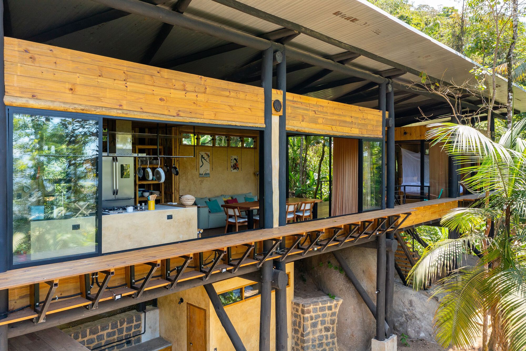 Timber-framed facade with steel columns and exposed diagonal bracing on upper level deck