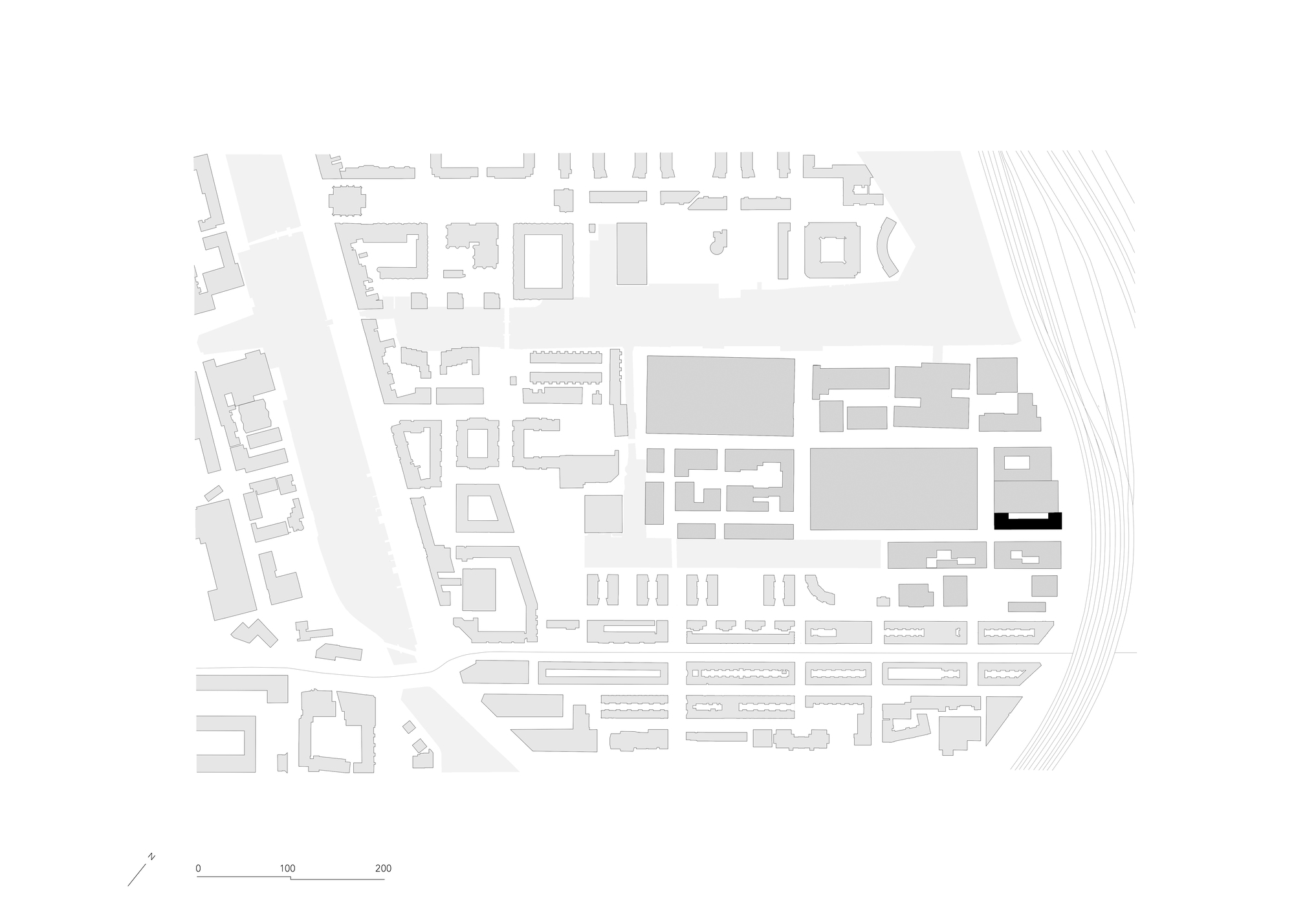 Site plan drawing showing building location within surrounding urban block and rail lines