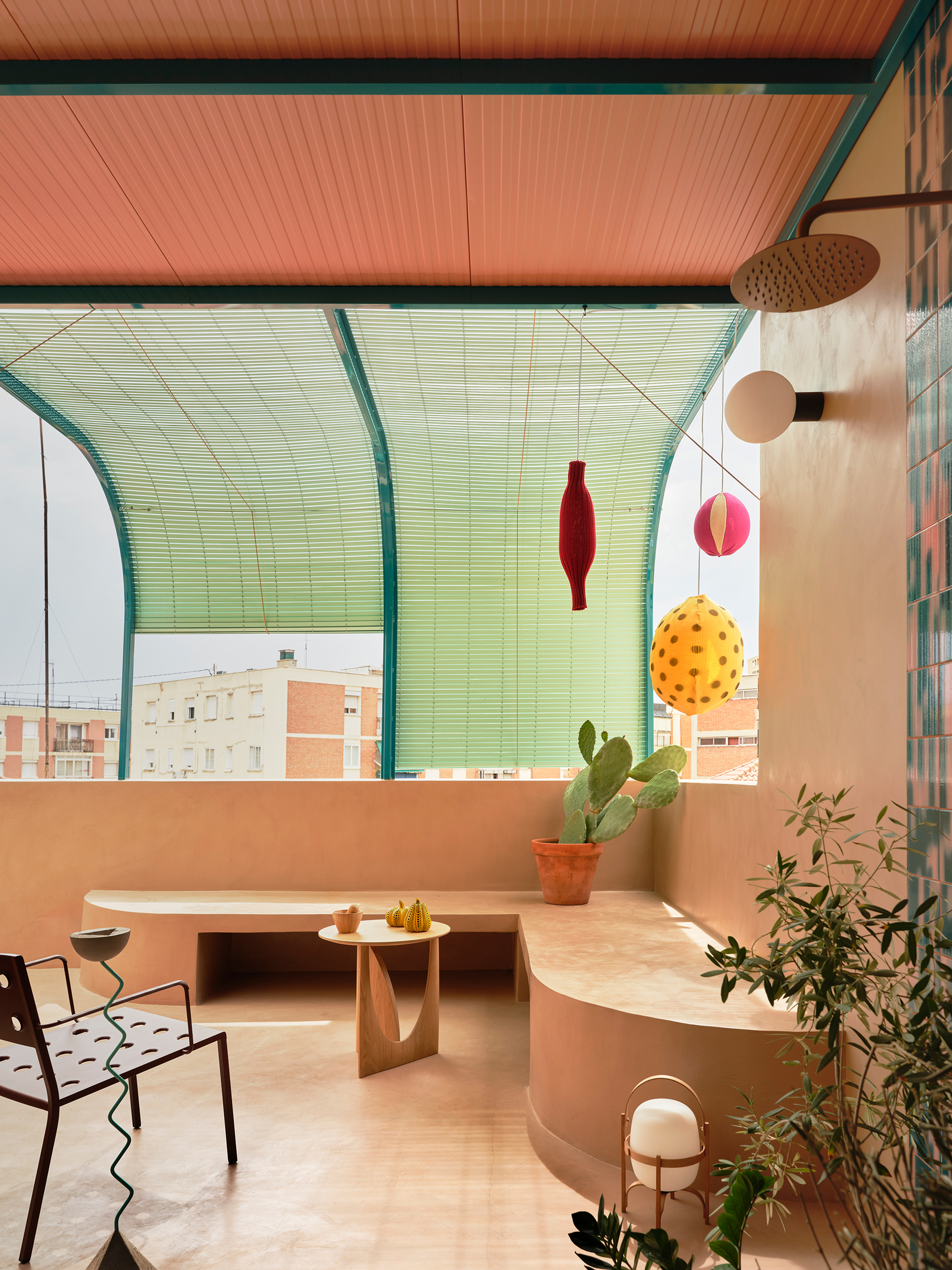 Covered terrace with lime green corrugated canopy, copper ceiling panels, and hanging pendant lights