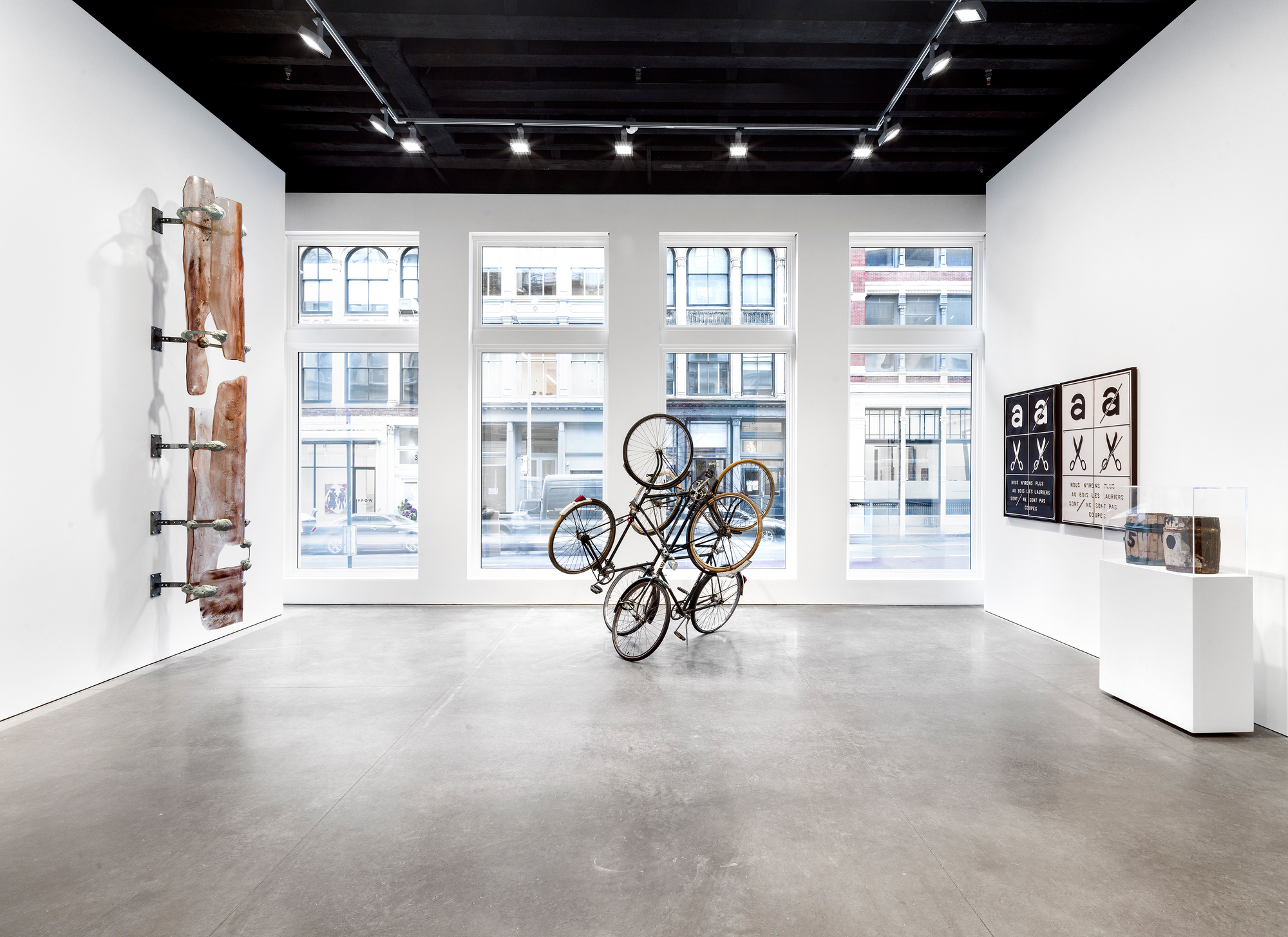Gallery space with tall arched windows overlooking the street and polished concrete floor