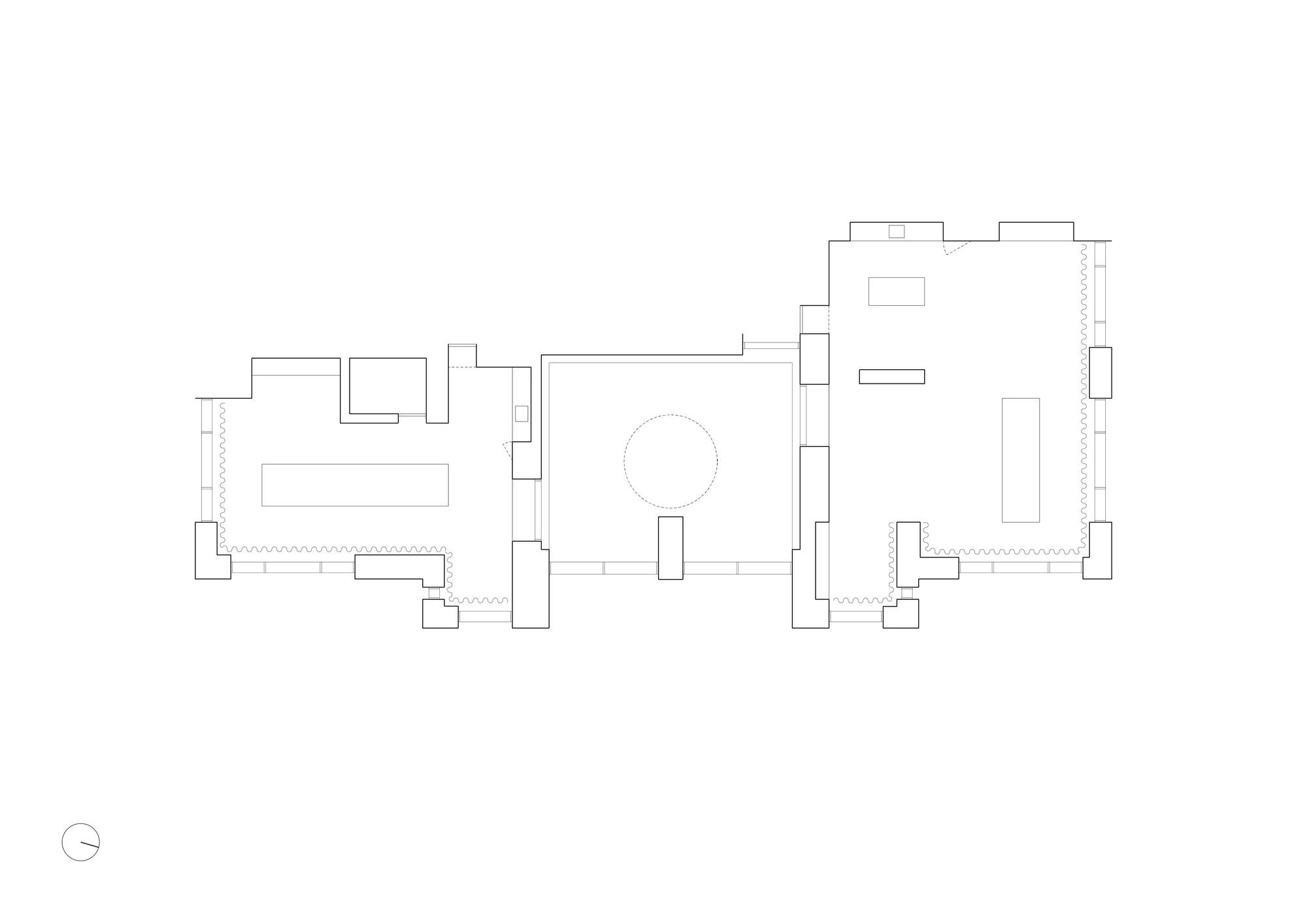 Floor plan drawing showing three rooms linked around a central circular element with north arrow