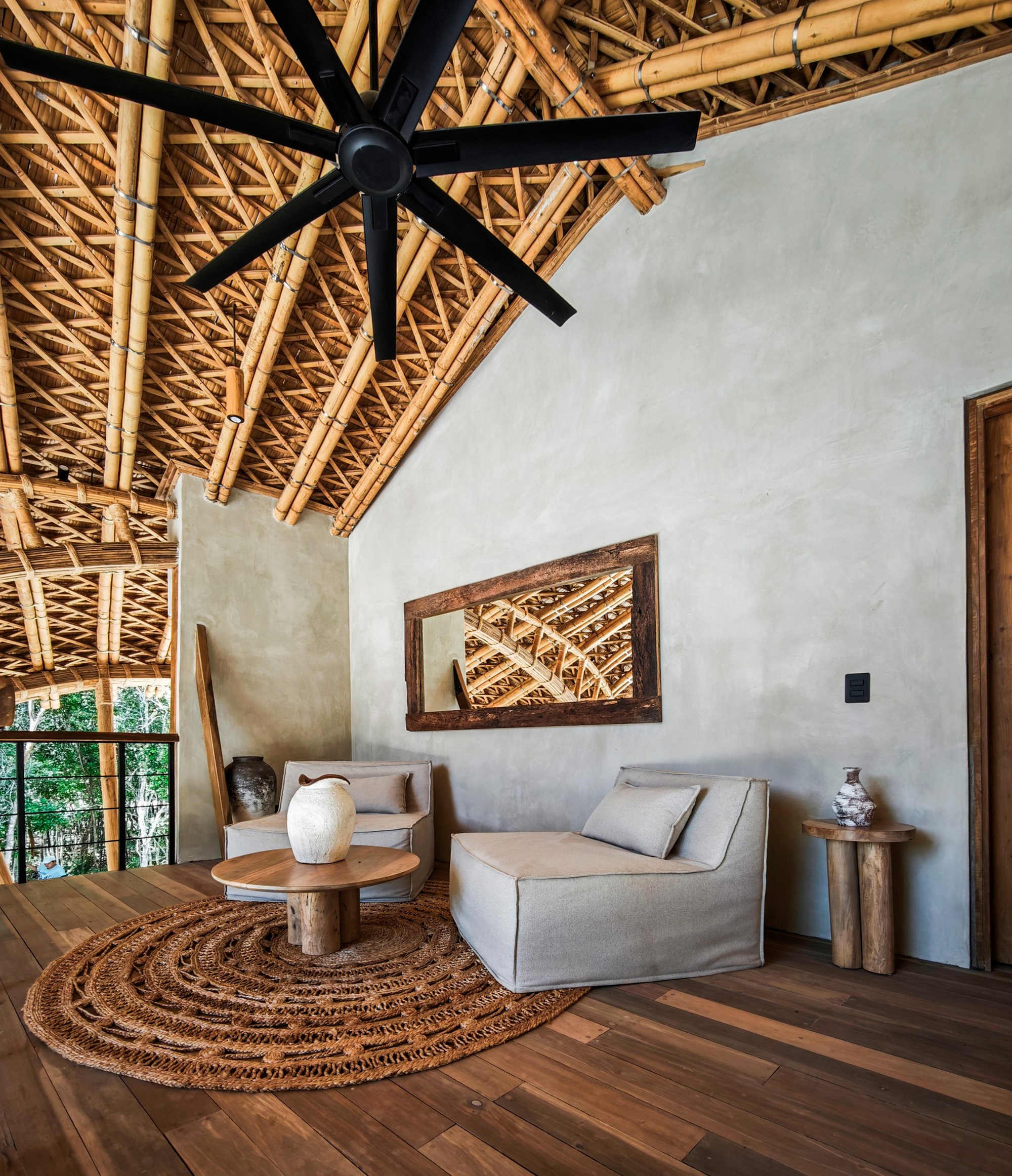 Interior view showing the exposed bamboo lattice ceiling with a black ceiling fan and white walls
