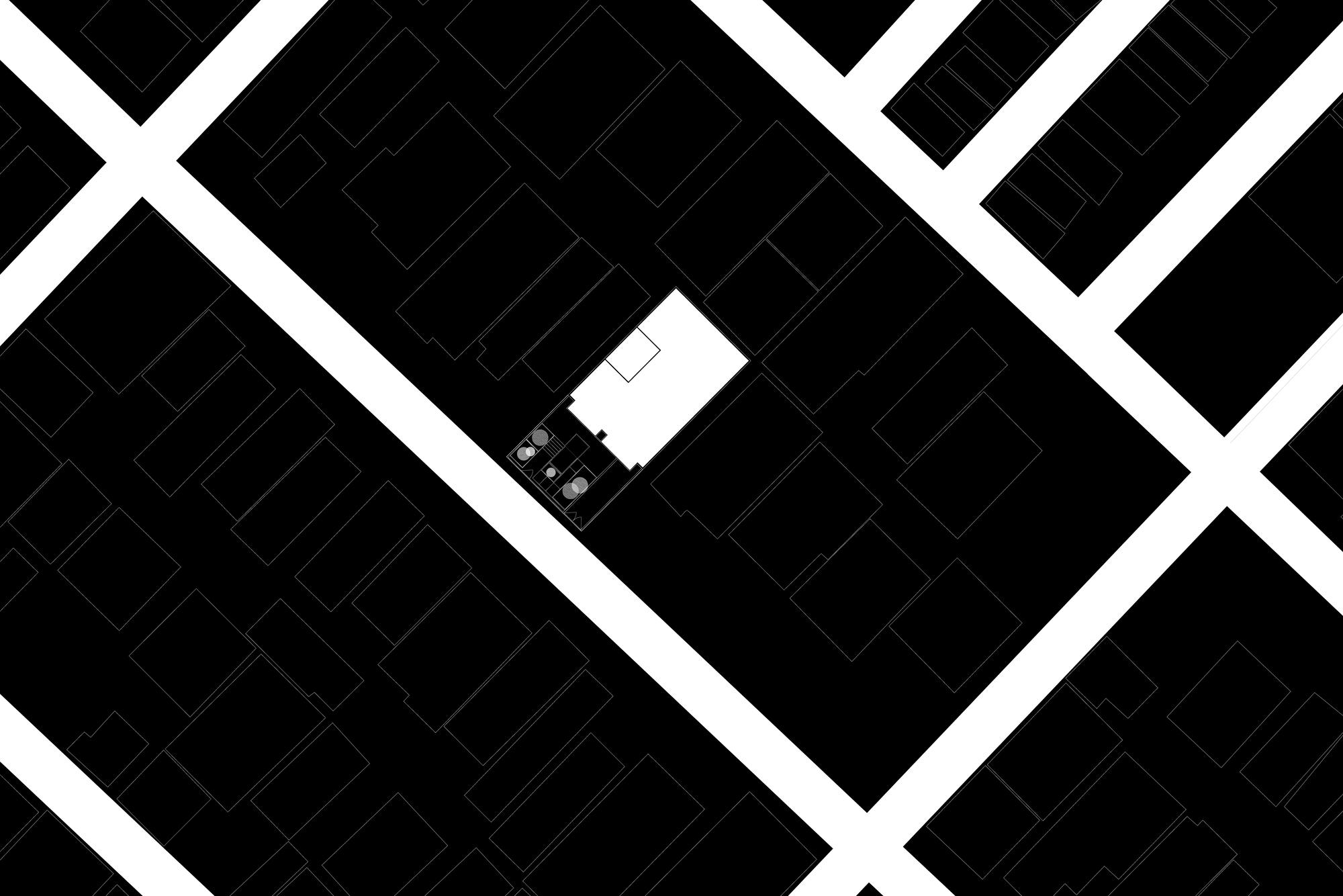 Site plan drawing showing the rectangular building footprint within the surrounding urban block