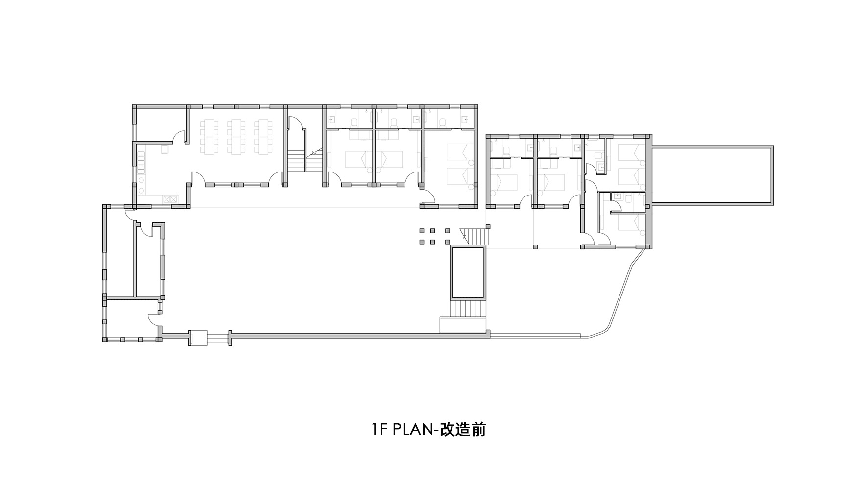 Floor plan drawing showing an L-shaped residential layout with multiple rooms and two staircases